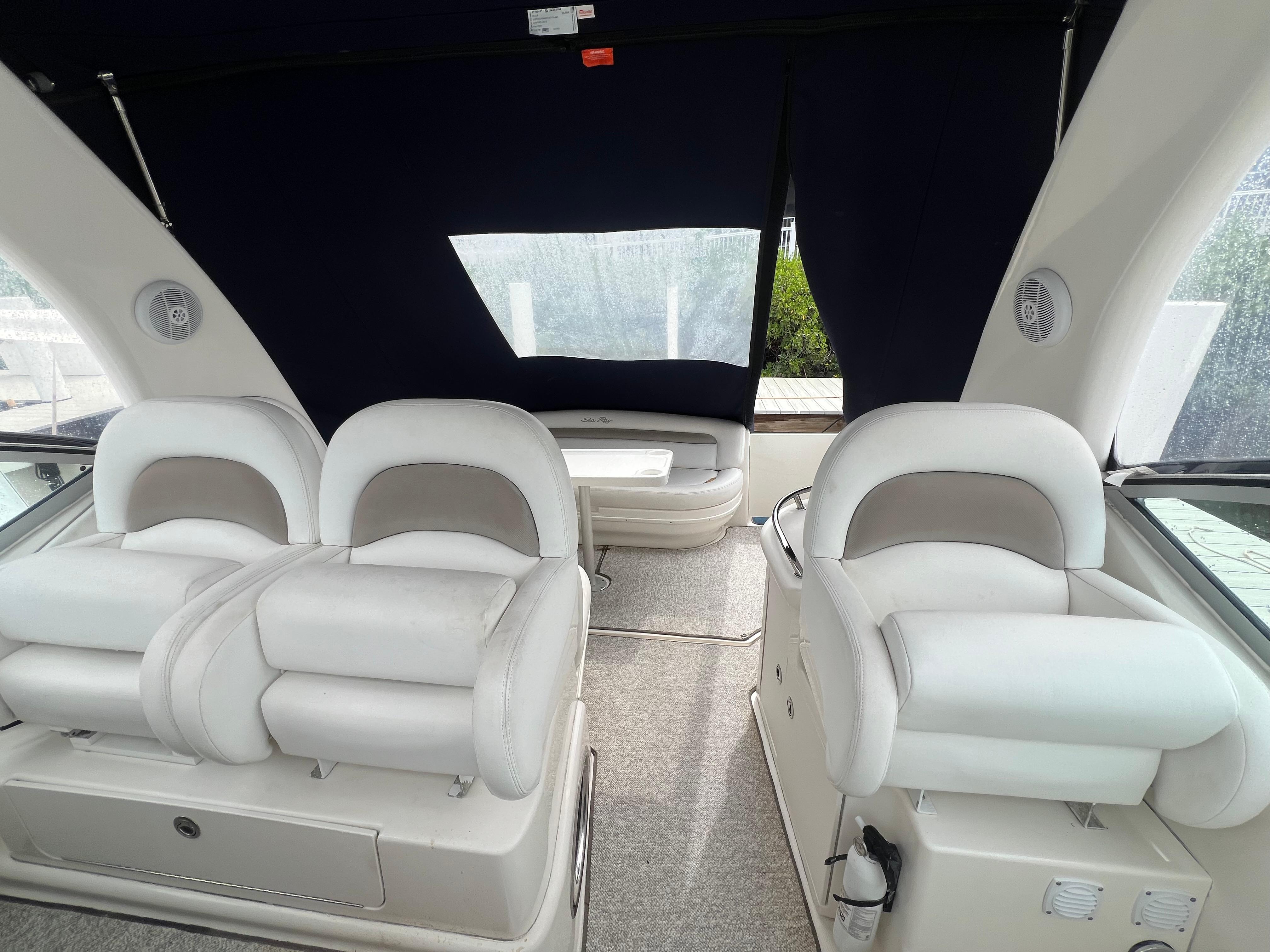 2005 Sea Ray 340 Sundancer interior with plush white seating and modern design.