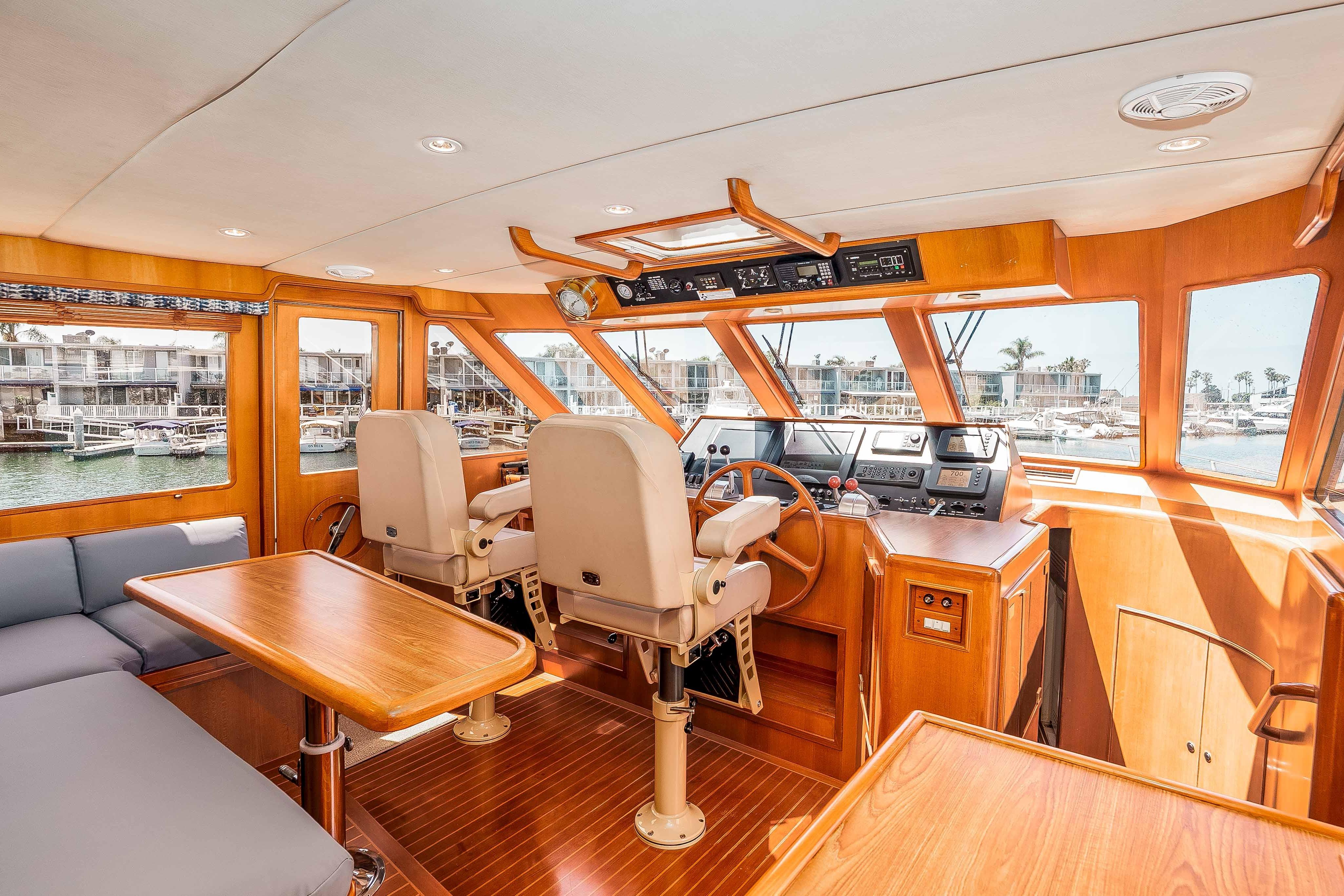 Pilothouse interior of 2005 Offshore Yachts 54 Pilothouse, featuring helm and seating area.