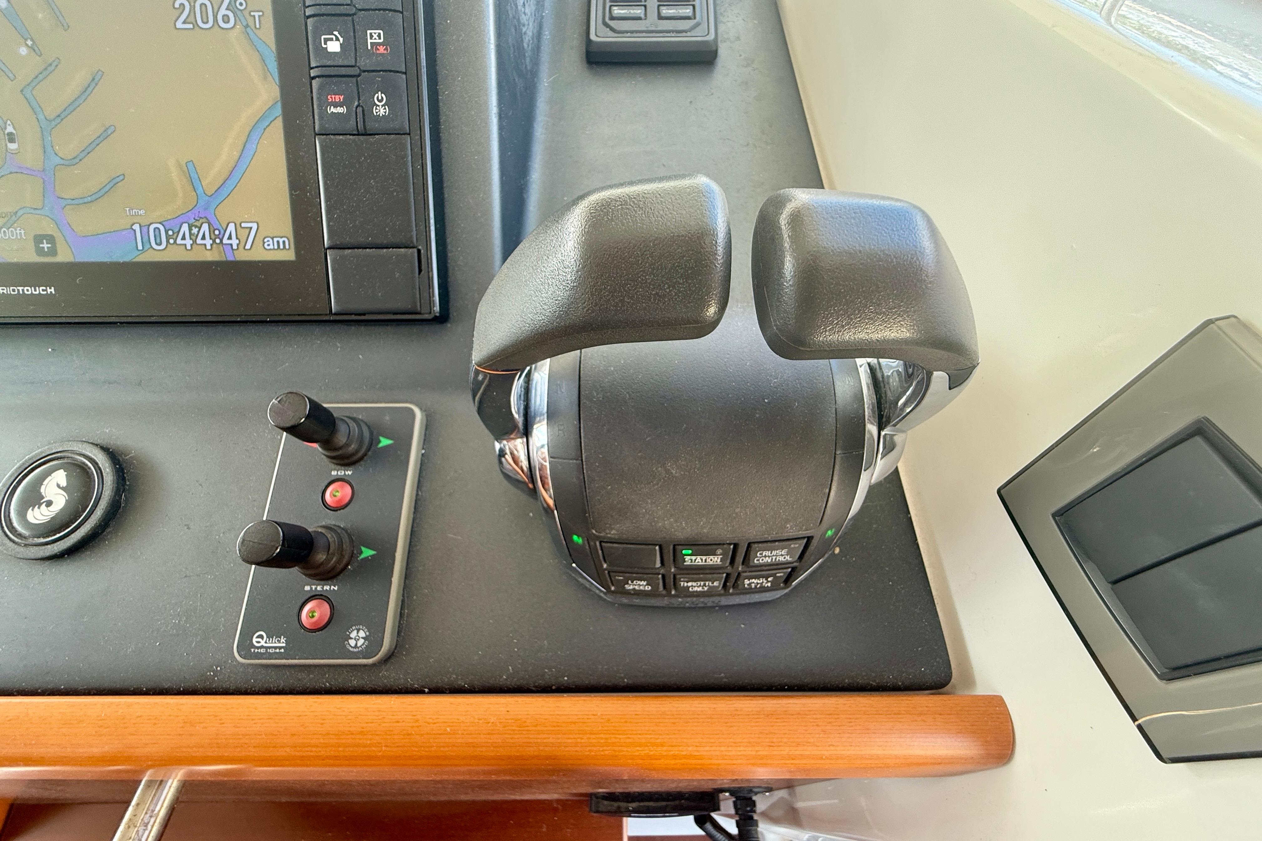 Control panel of a 2020 Beneteau Swift Trawler 44 with navigation and throttle controls.