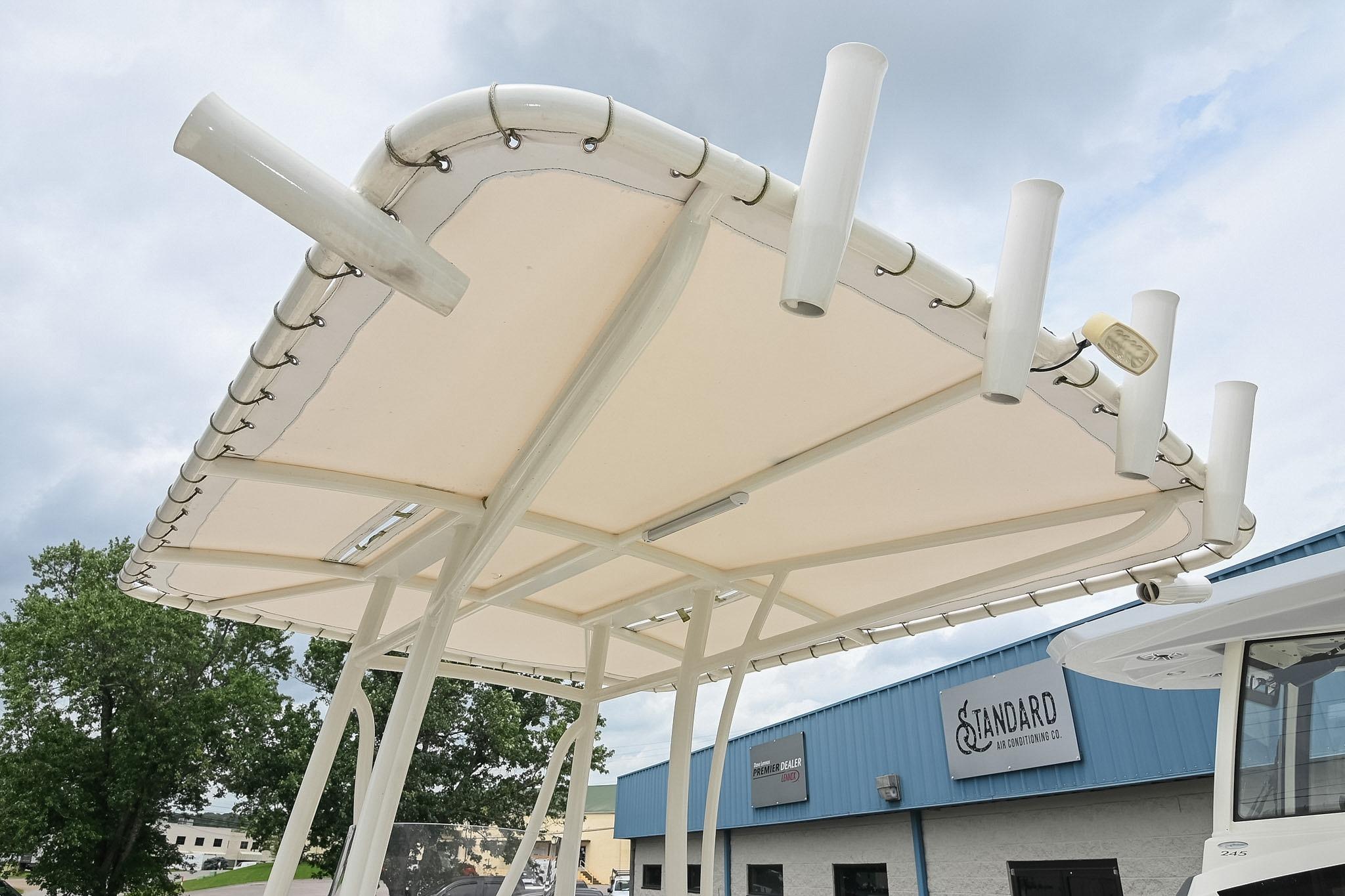 T-top of 2021 Pathfinder 2200 TRS boat with rod holders, against cloudy sky.