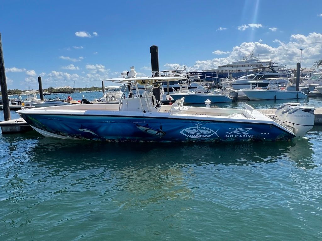 2006 Venture 39 Open boat docked with shark design.