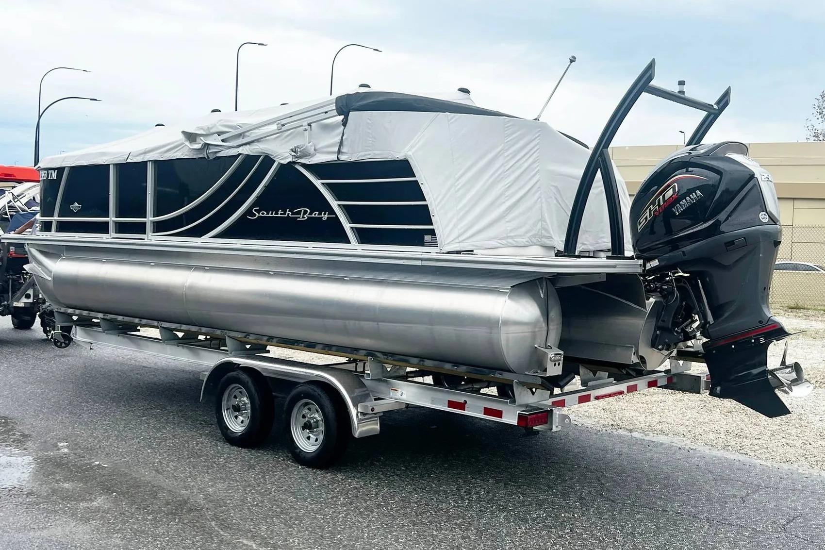 2023 South Bay 523 R pontoon boat on trailer with Yamaha outboard motor.