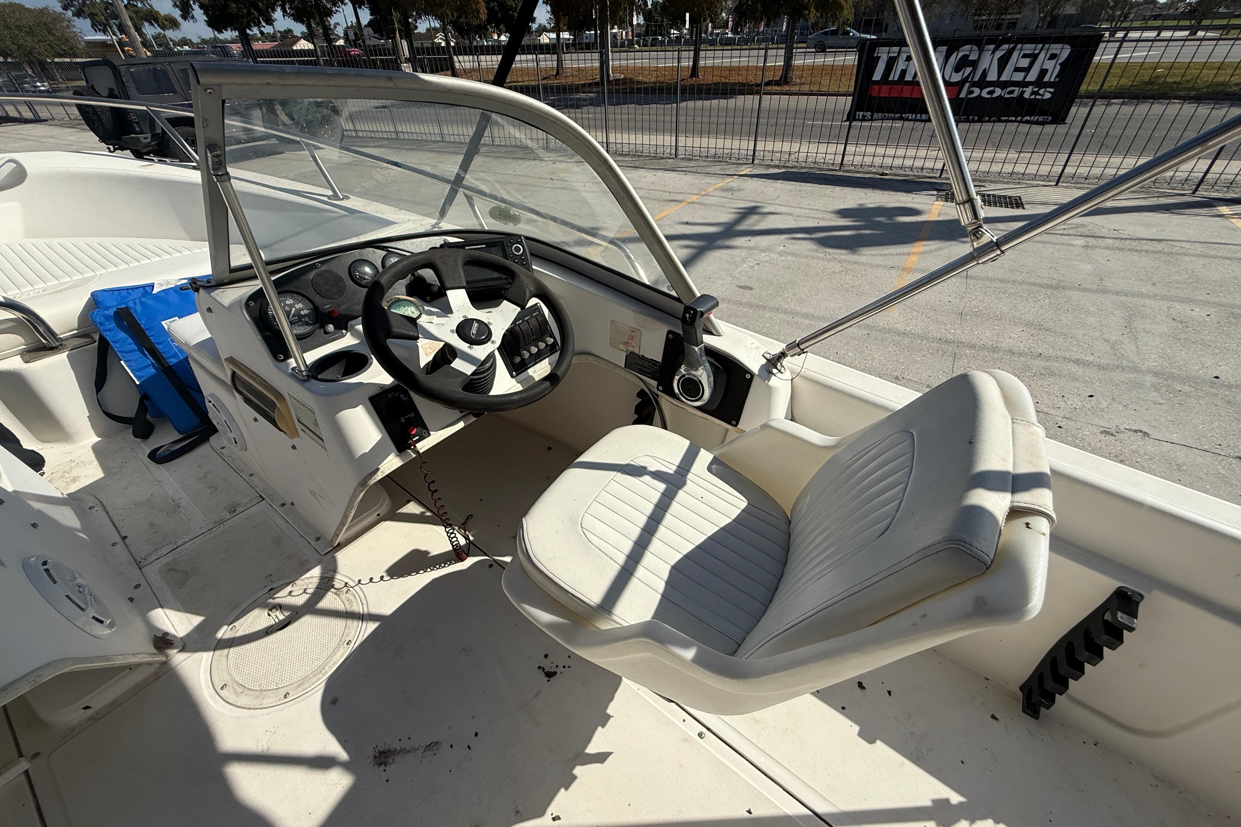 2002 Boston Whaler Ventura 160 boat interior with steering wheel and seating.
