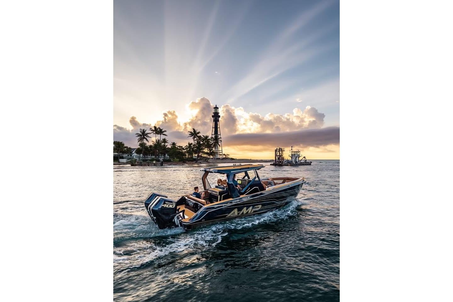 Boat cruising near lighthouse at sunset, AMP 34S model, 2027.