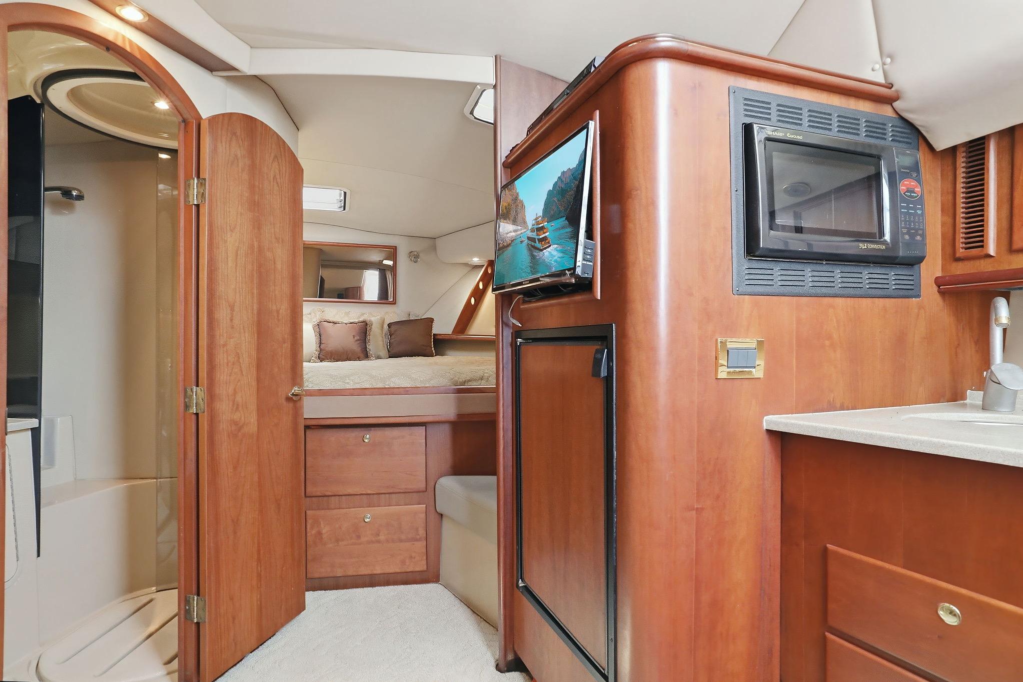 Interior of 2005 Rampage 38 Express yacht with kitchenette, bed, and bathroom.