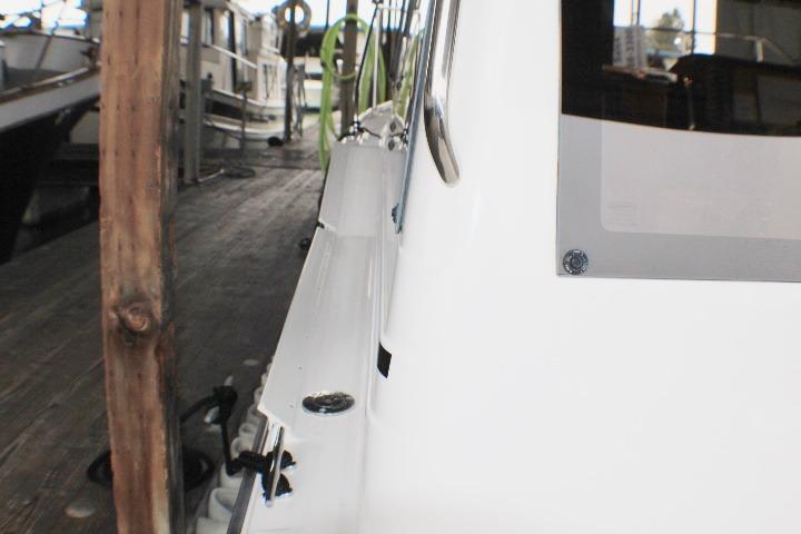 2020 Ranger Tugs R-27 docked, showcasing sleek white exterior and marina setting.