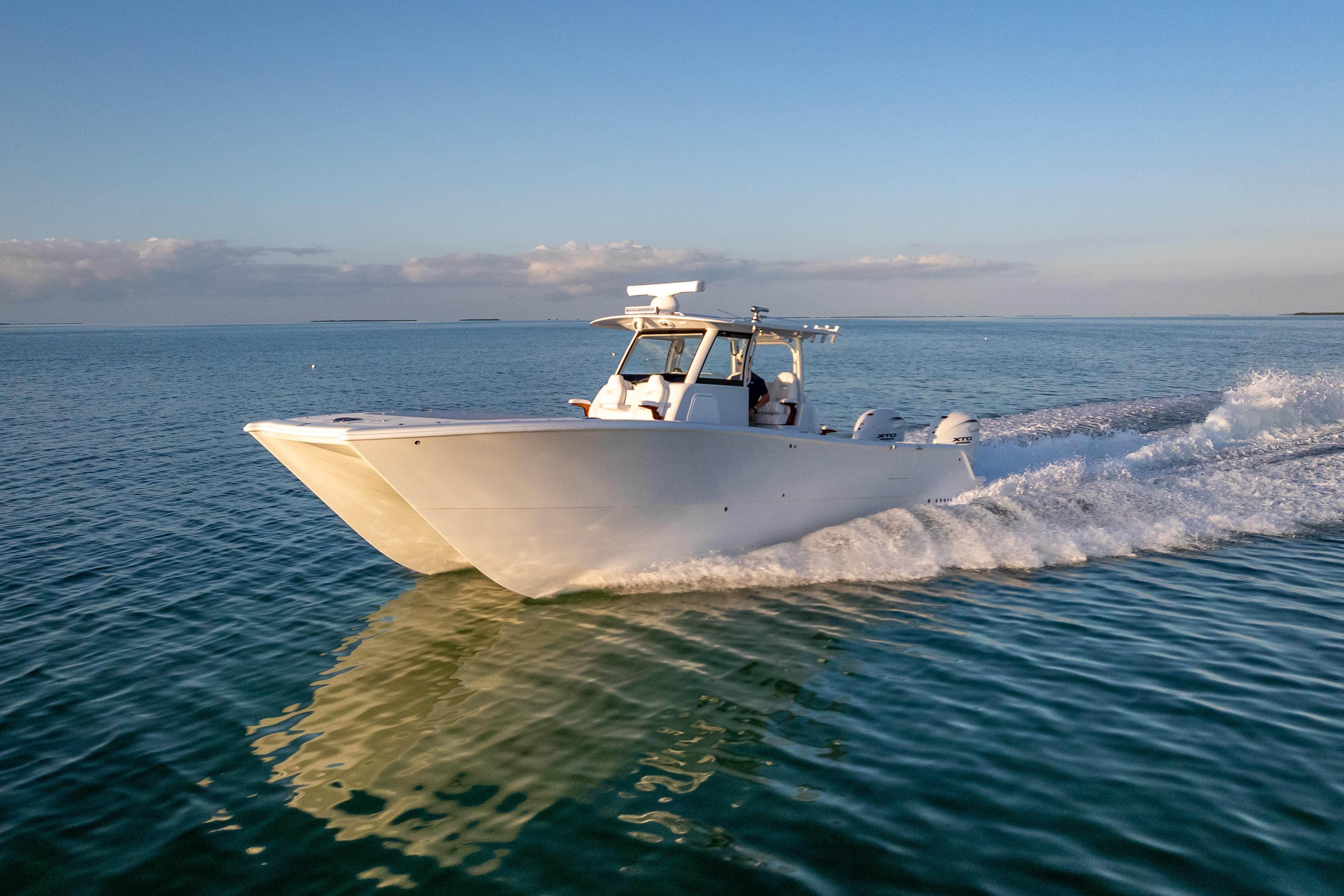 2026 Freeman 35 boat cruising on calm ocean waters under a clear blue sky.