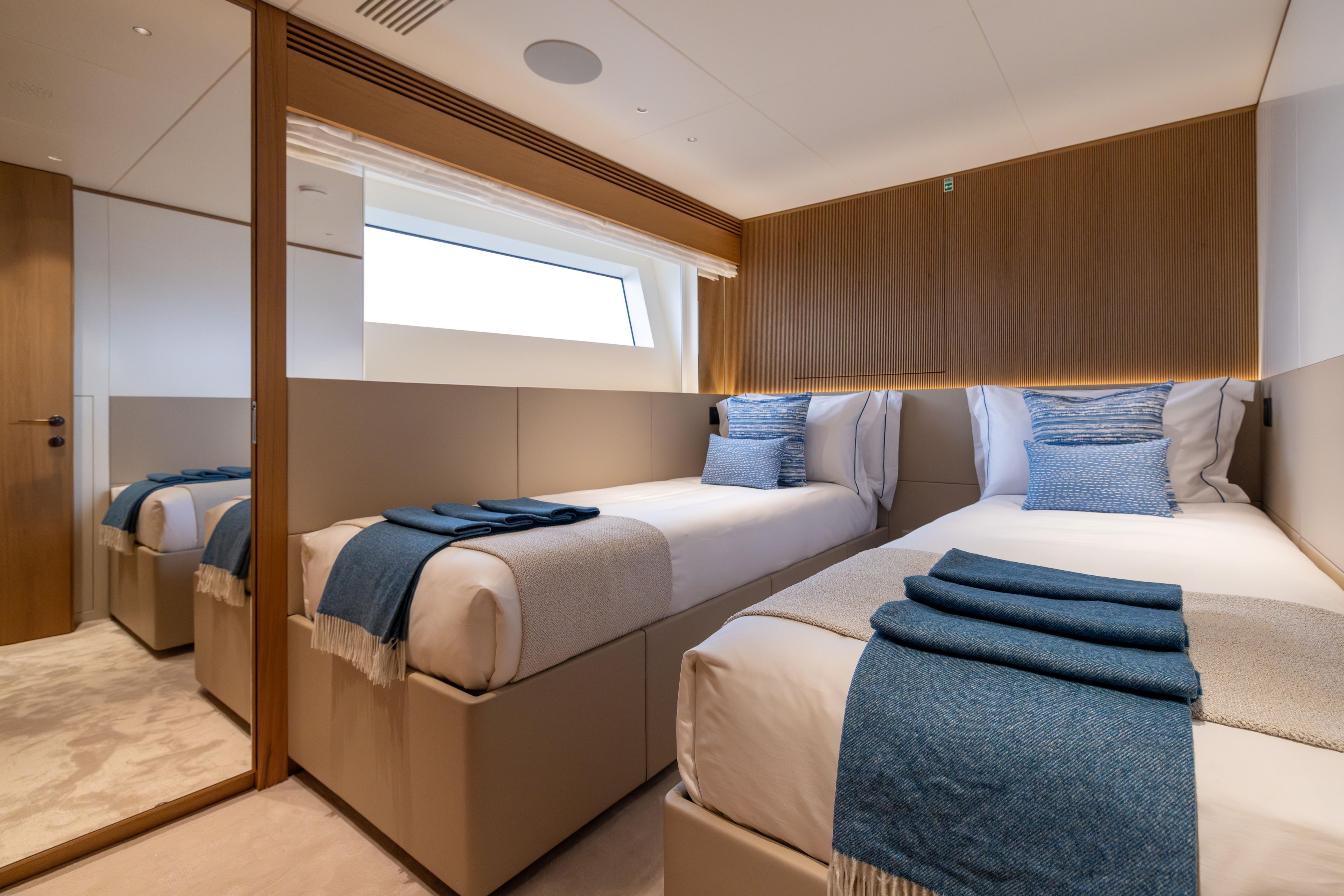 Luxurious twin bedroom on 2024 Benetti Oasis 34M yacht, featuring modern design and elegant decor.