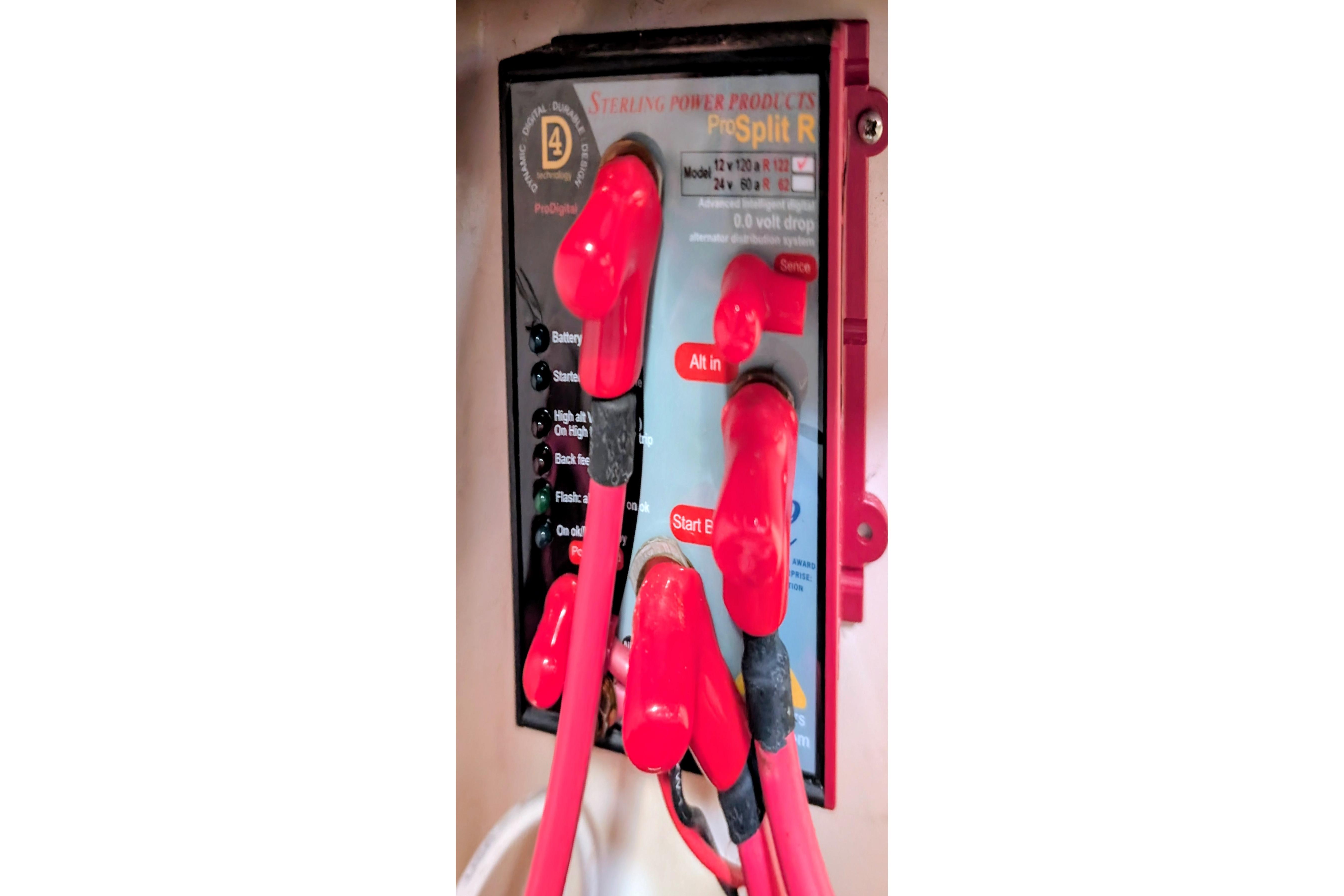 Electrical panel with red cables on a 1989 Catalina 34 boat.
