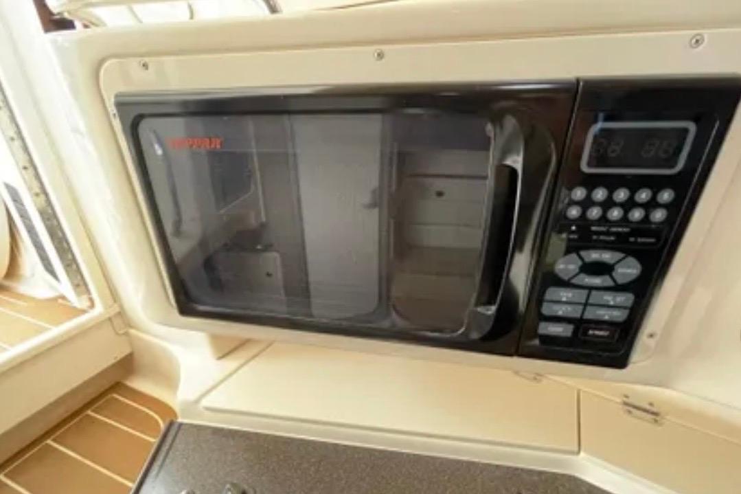 Built-in microwave on 2007 Grady-White Express 330 boat, featuring control panel and handle.