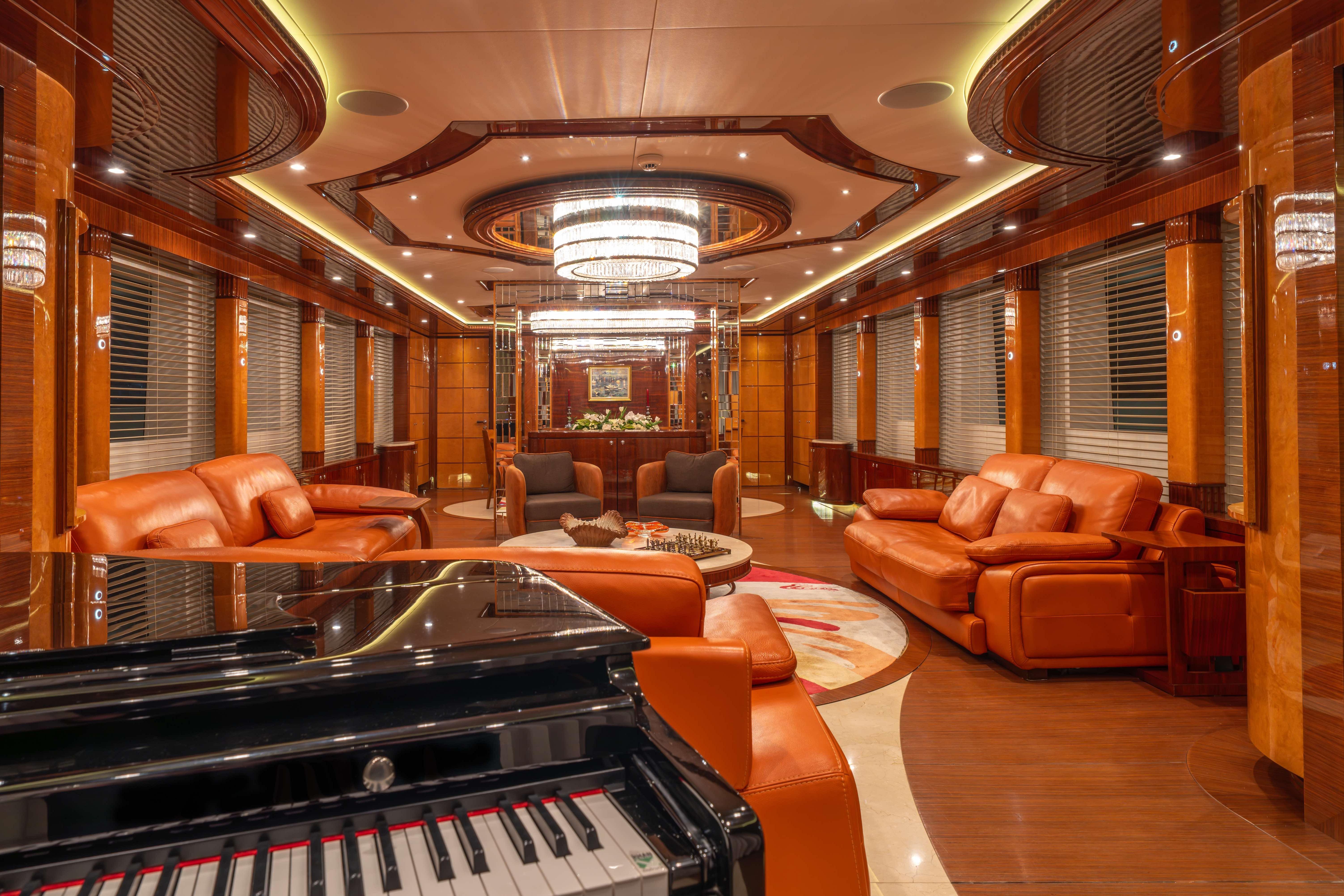 Luxurious interior of 2014 Bilgin 147 yacht with elegant leather seating and grand piano.
