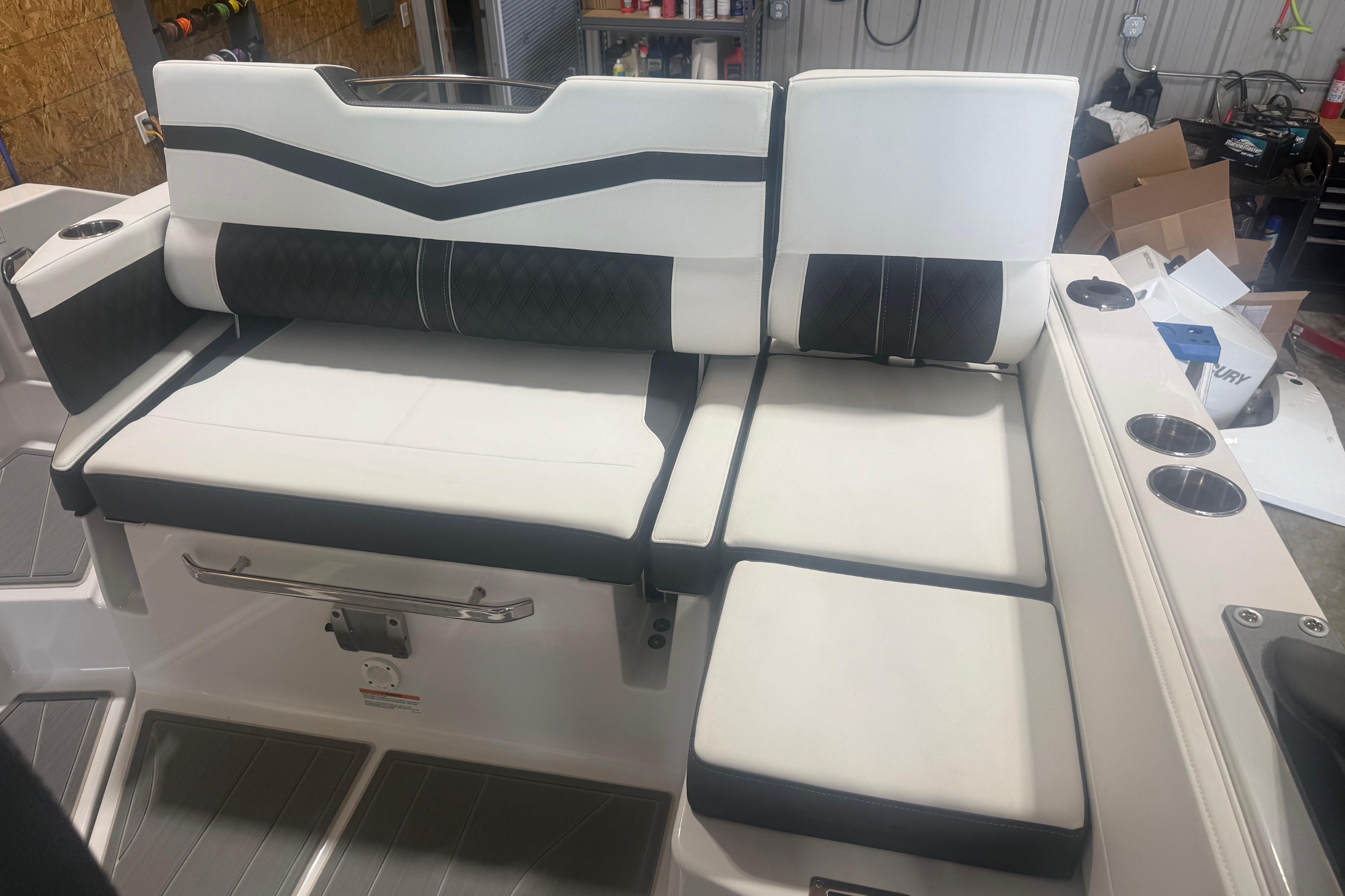 Luxurious seating on 2027 Monterey Elite 27 SD boat, featuring sleek design and cup holders.