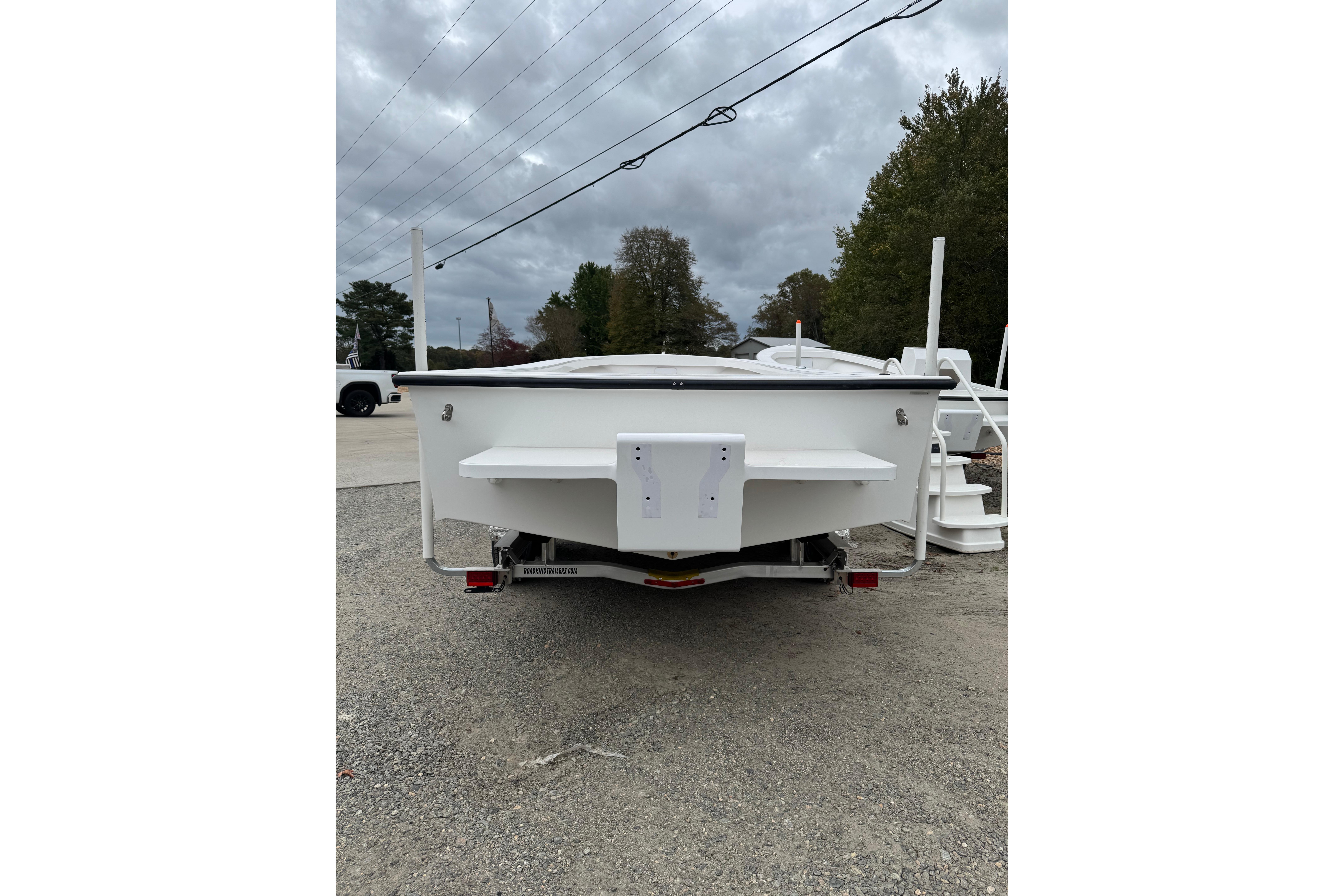 2026 C-Hawk 26 Center Console boat on trailer, rear view, overcast sky.