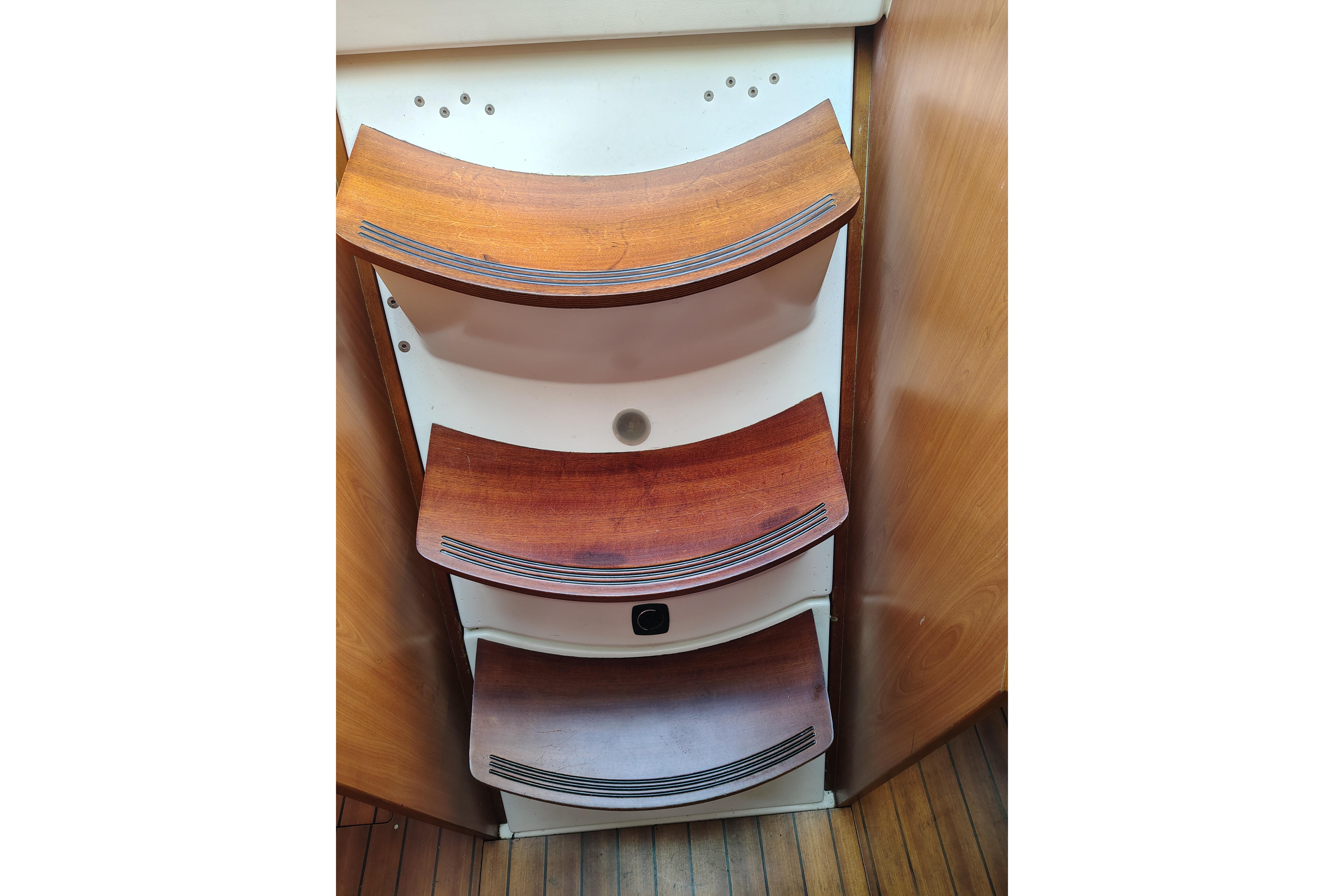Wooden steps inside a 2001 Beneteau Oceanis 411 yacht, showcasing elegant marine craftsmanship.