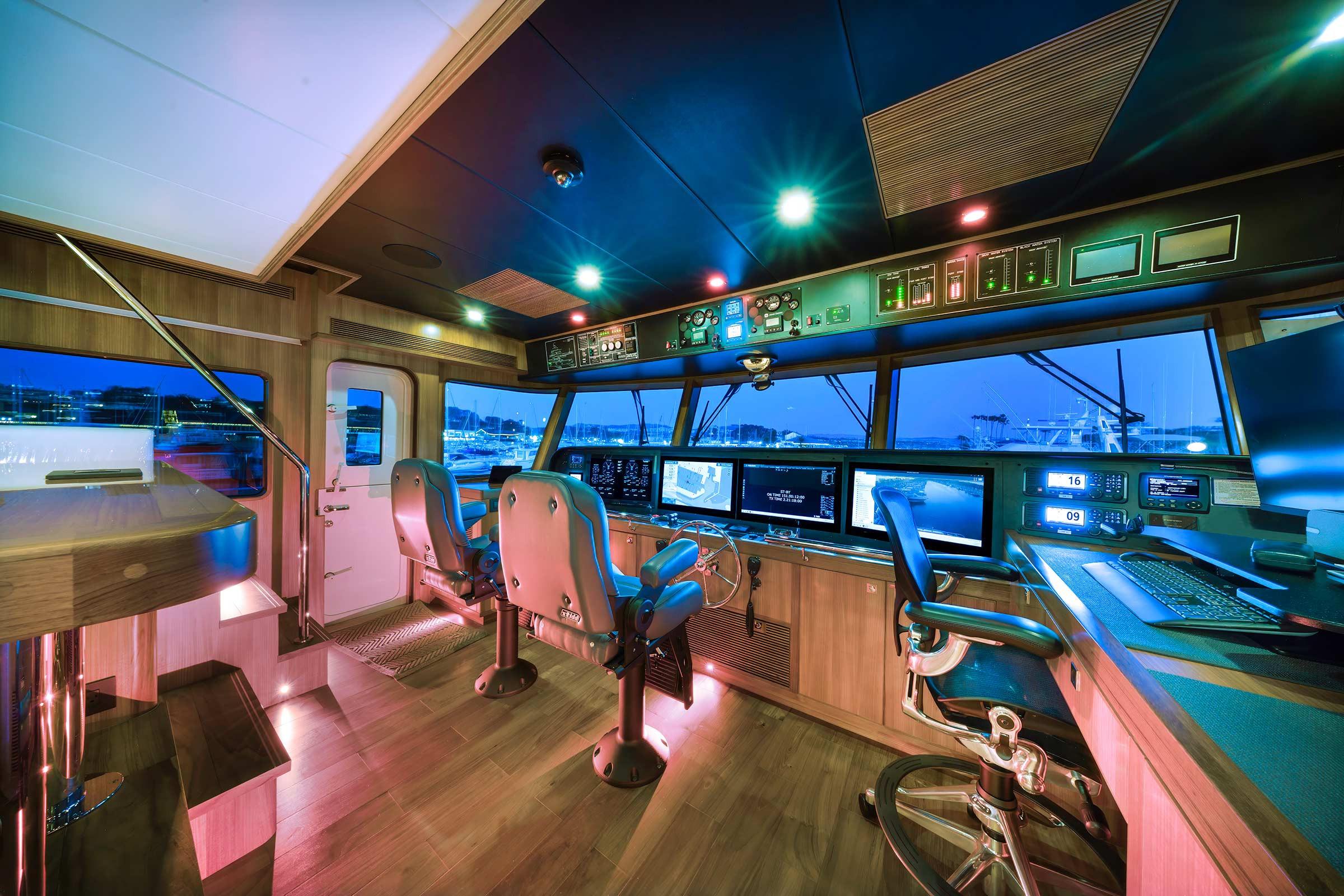 Modern helm of 2025 Nordhavn 71 yacht with advanced navigation systems and luxurious seating.