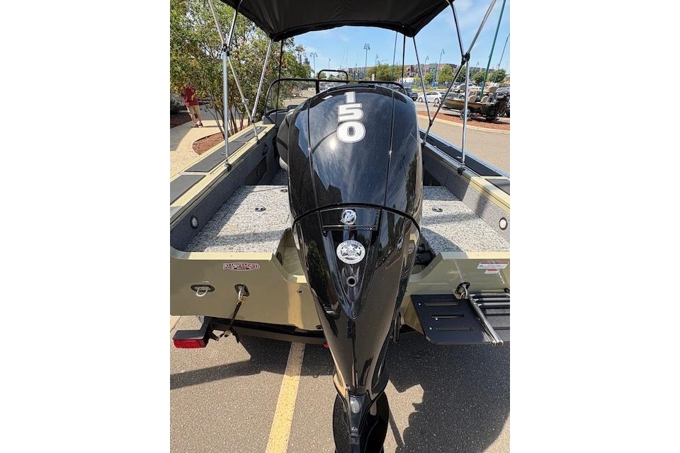 2026 Tracker Targa V-18 WT boat with 150 HP engine, parked outdoors.