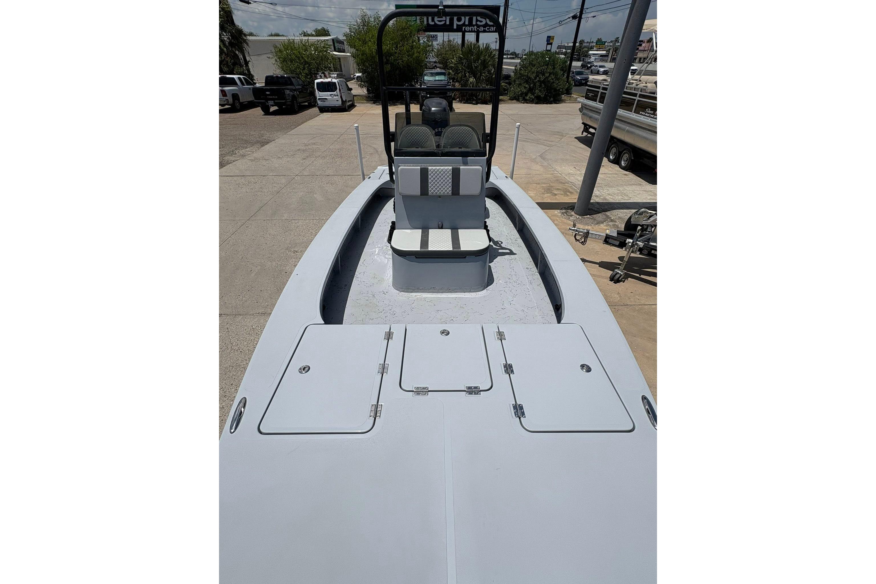2026 Freedom Boats 23' Warrior, spacious deck view, parked outdoors.