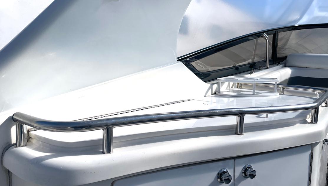 2002 Fountain 38 Express Cruiser, sleek white deck with stainless steel railings.