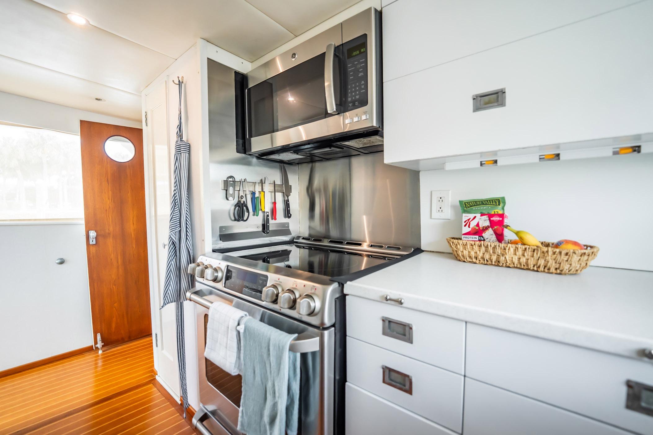 Modern kitchen interior on 1972 Trumpy 72 Motor Yacht with stainless steel appliances.