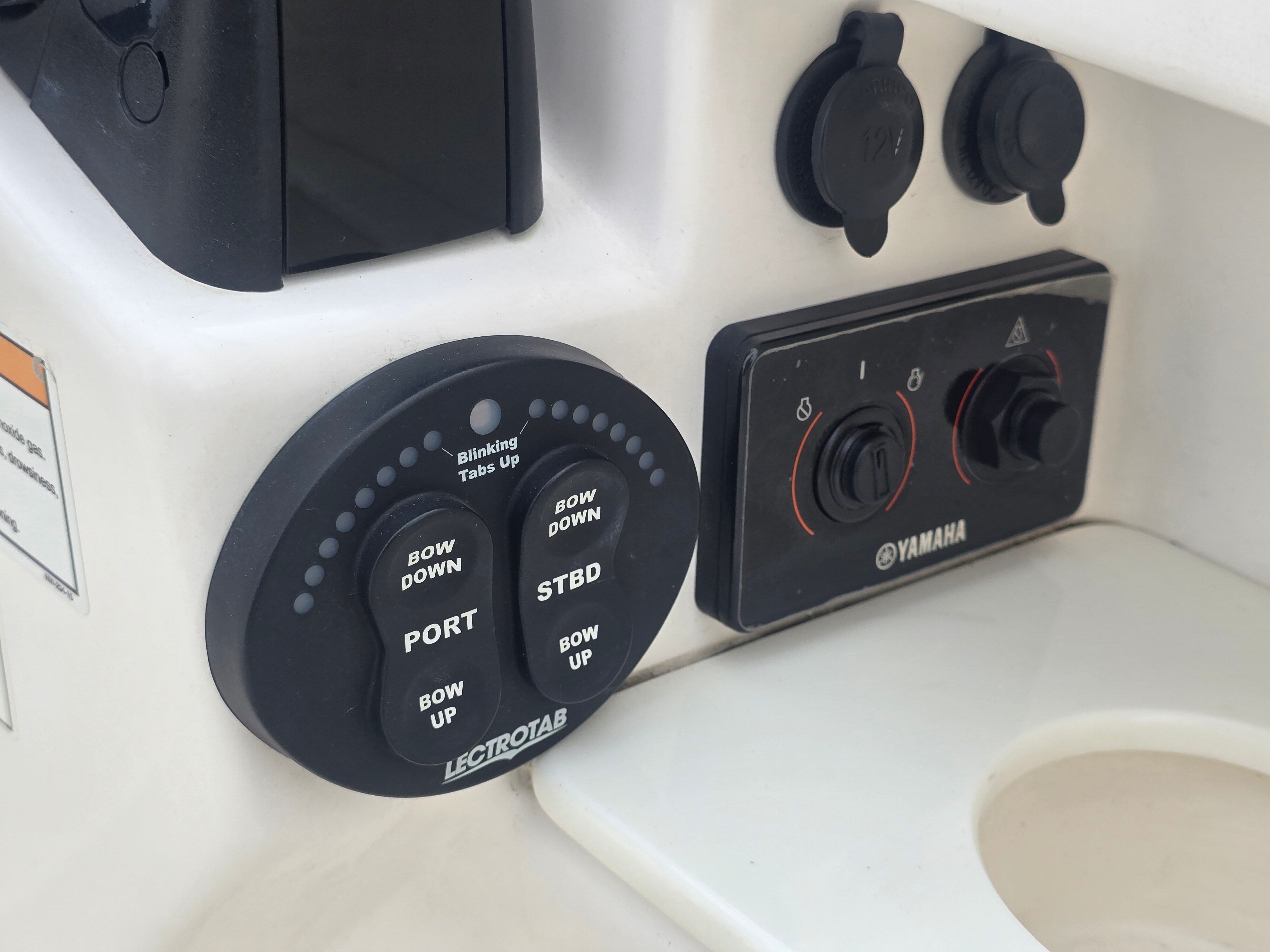 Controls and switches on a boat, including Yamaha controls.