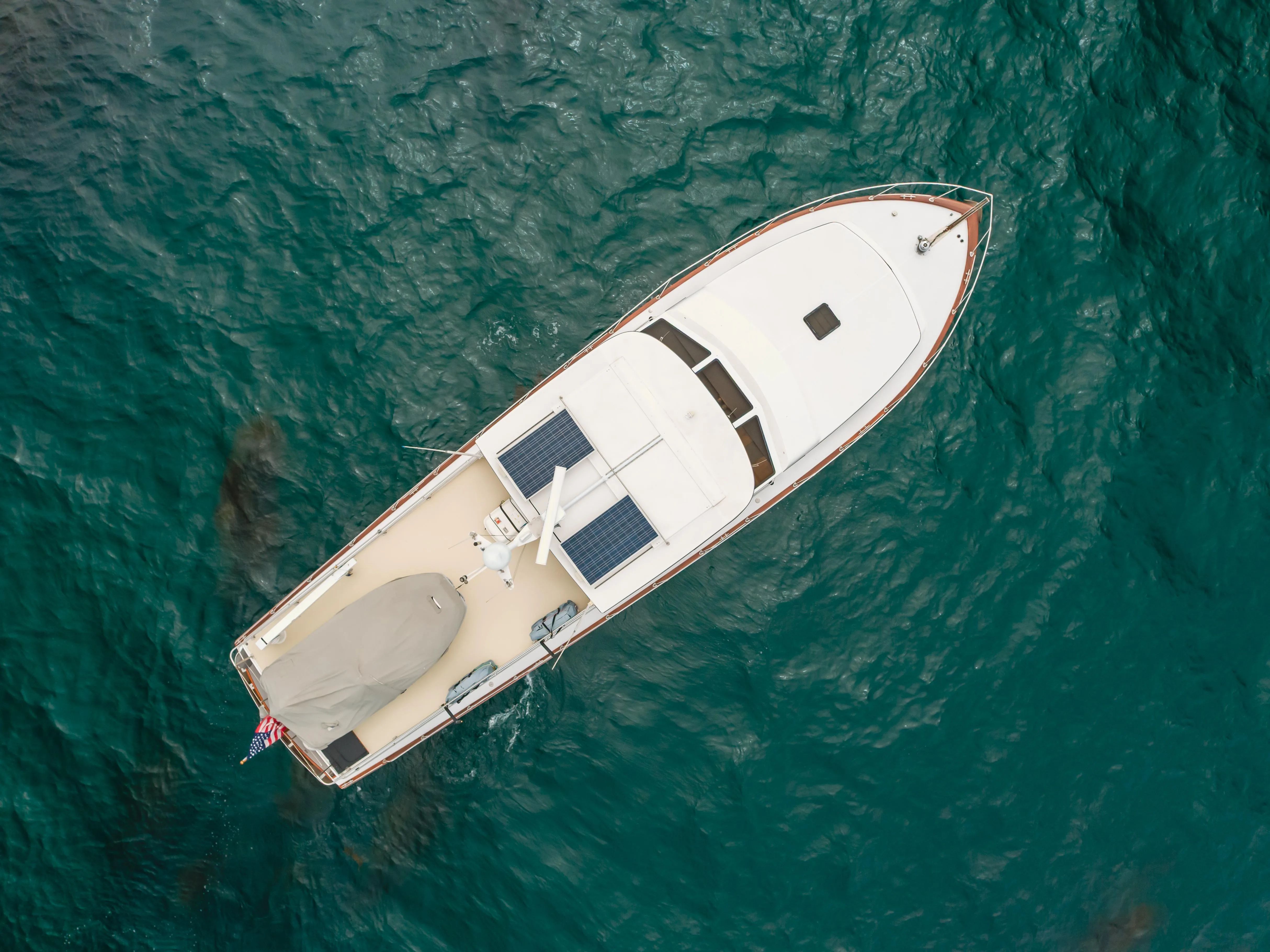 Aerial view of 1984 Vic Franck Pilot House on blue water.