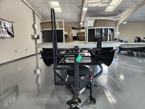 2025 Ranger 200C pontoon boat on trailer in showroom, featuring sleek design and modern amenities.