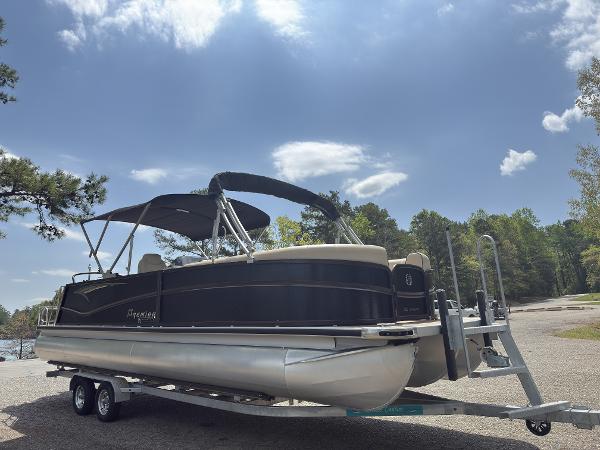 2022 Premier 250 Solaris pontoon boat on trailer under clear sky.