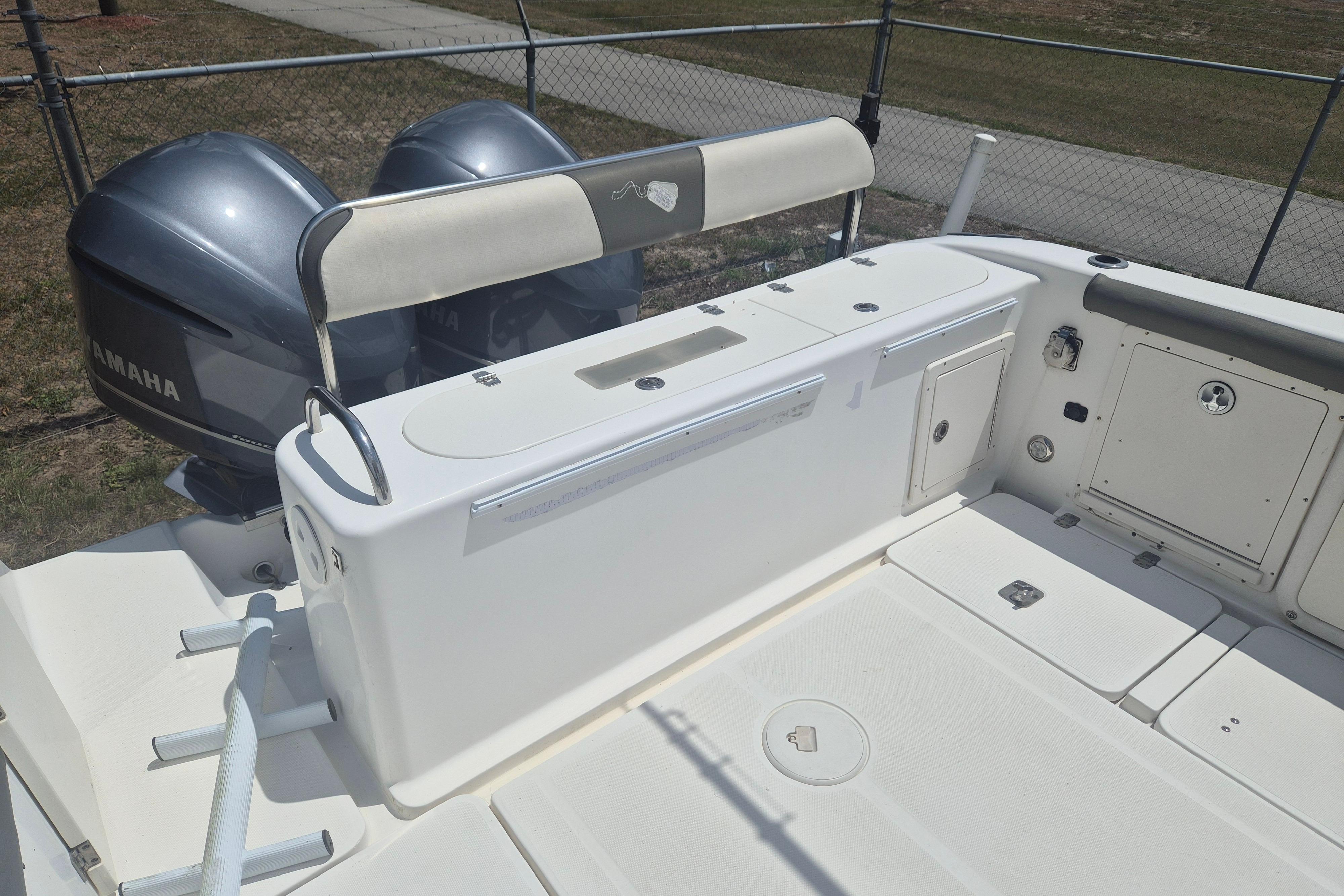 2006 Century 2900 Center Console boat with Yamaha engines, featuring spacious deck and storage compartments.