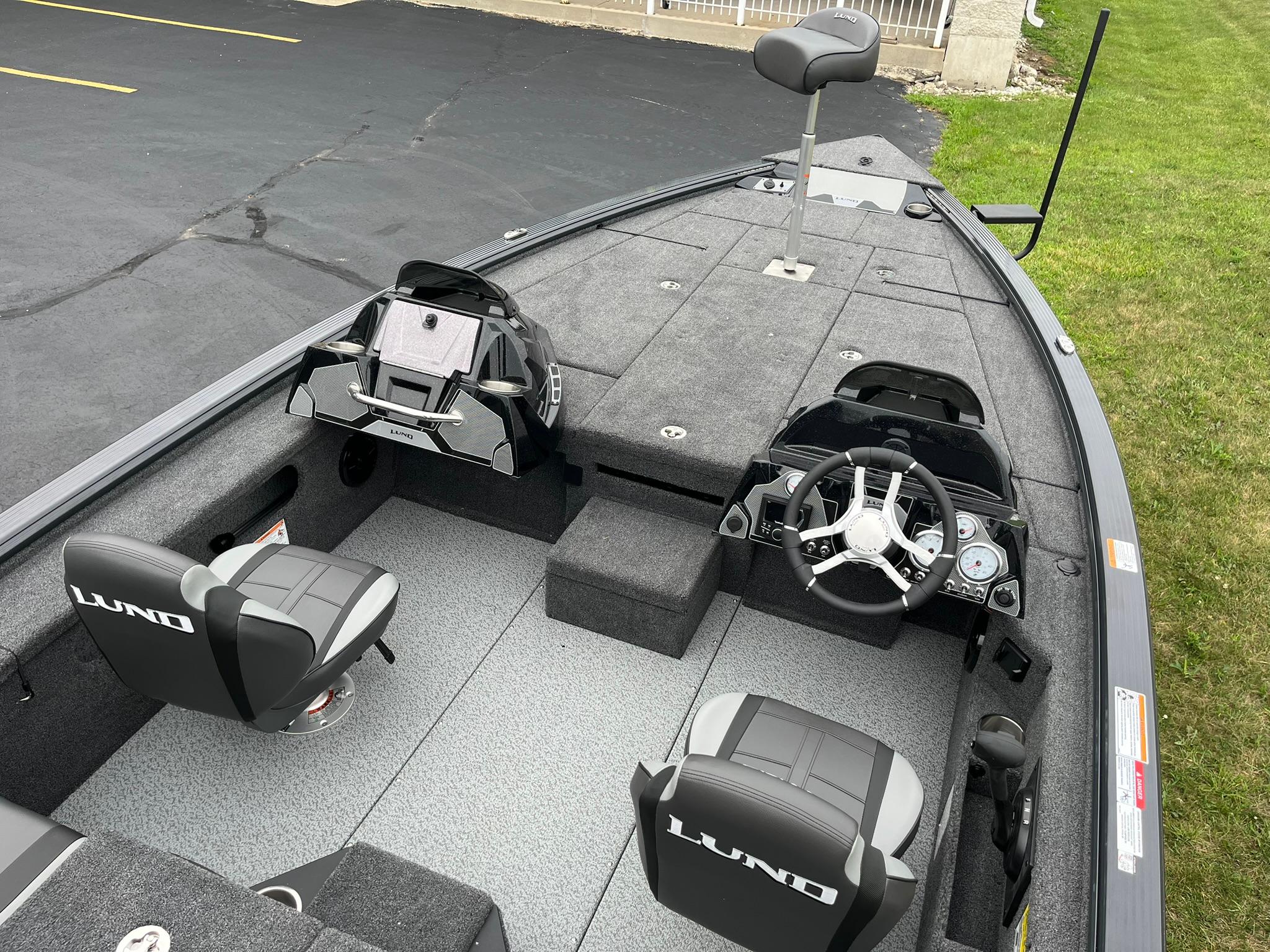 2026 Lund 1875 Pro-V Bass XS boat interior with dual seats and steering console.
