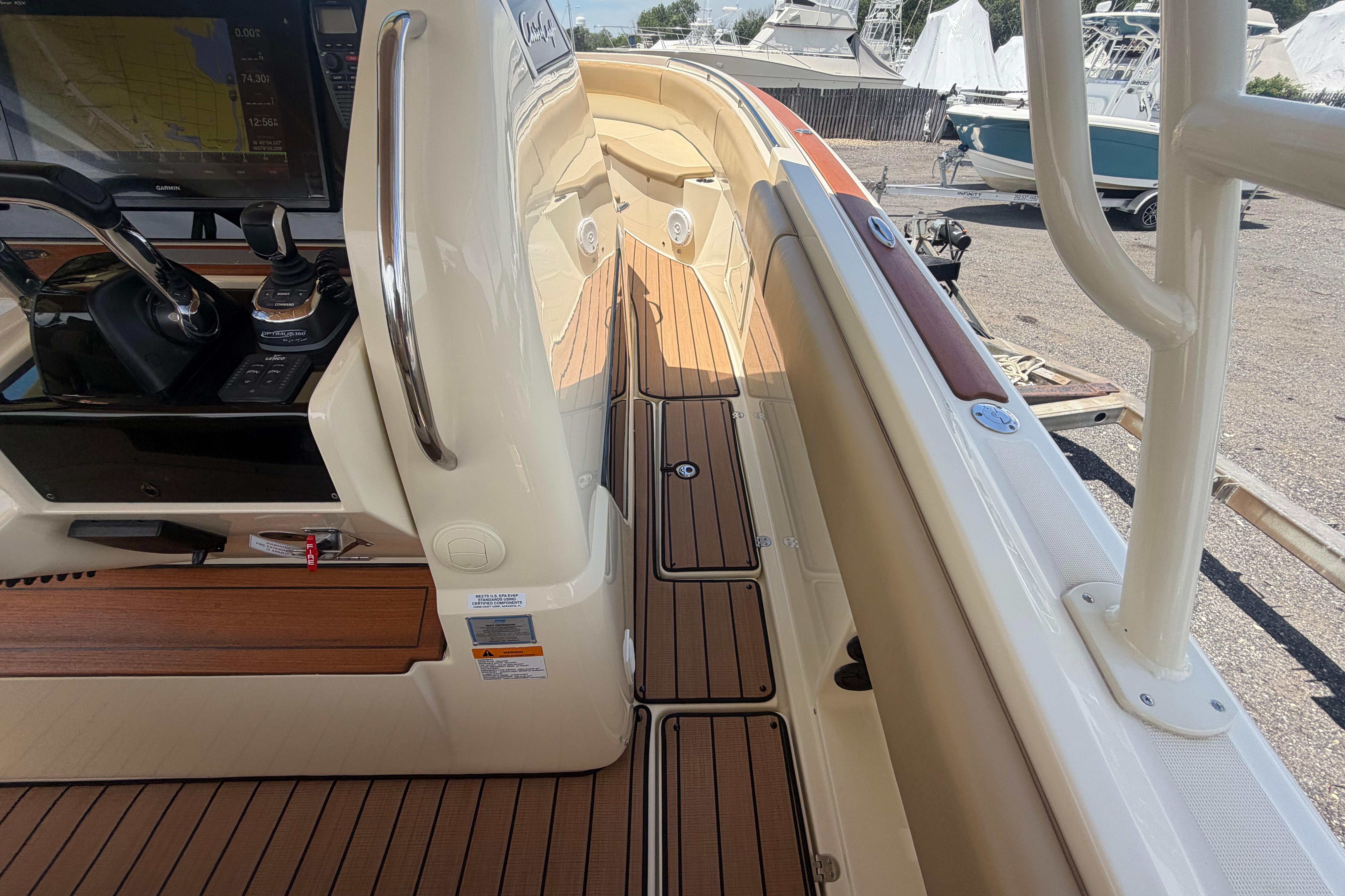 2017 Chris-Craft Catalina 34 boat interior with teak flooring and navigation controls.