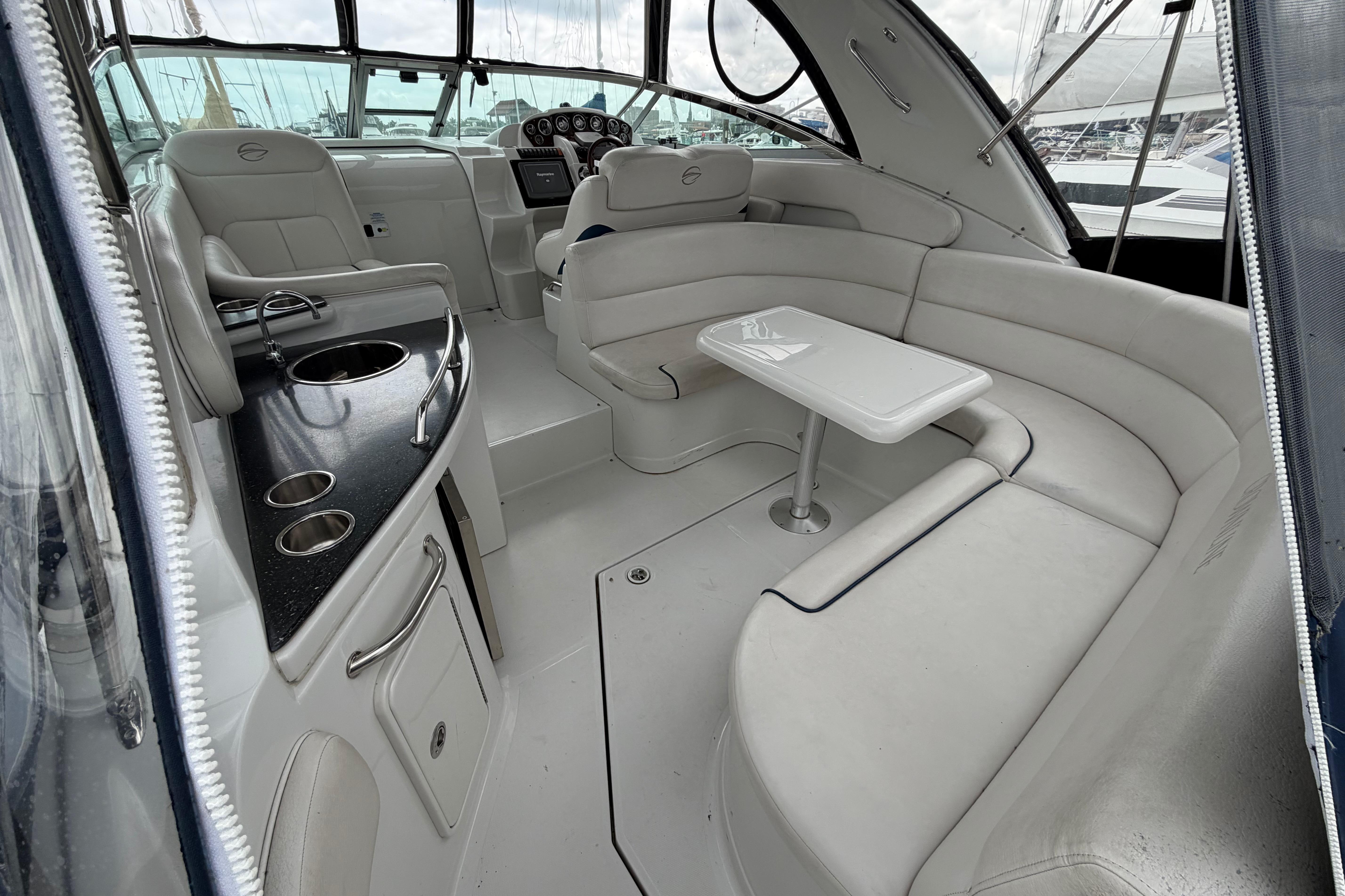 2008 Crownline 340 CR yacht interior with seating, table, and kitchenette.