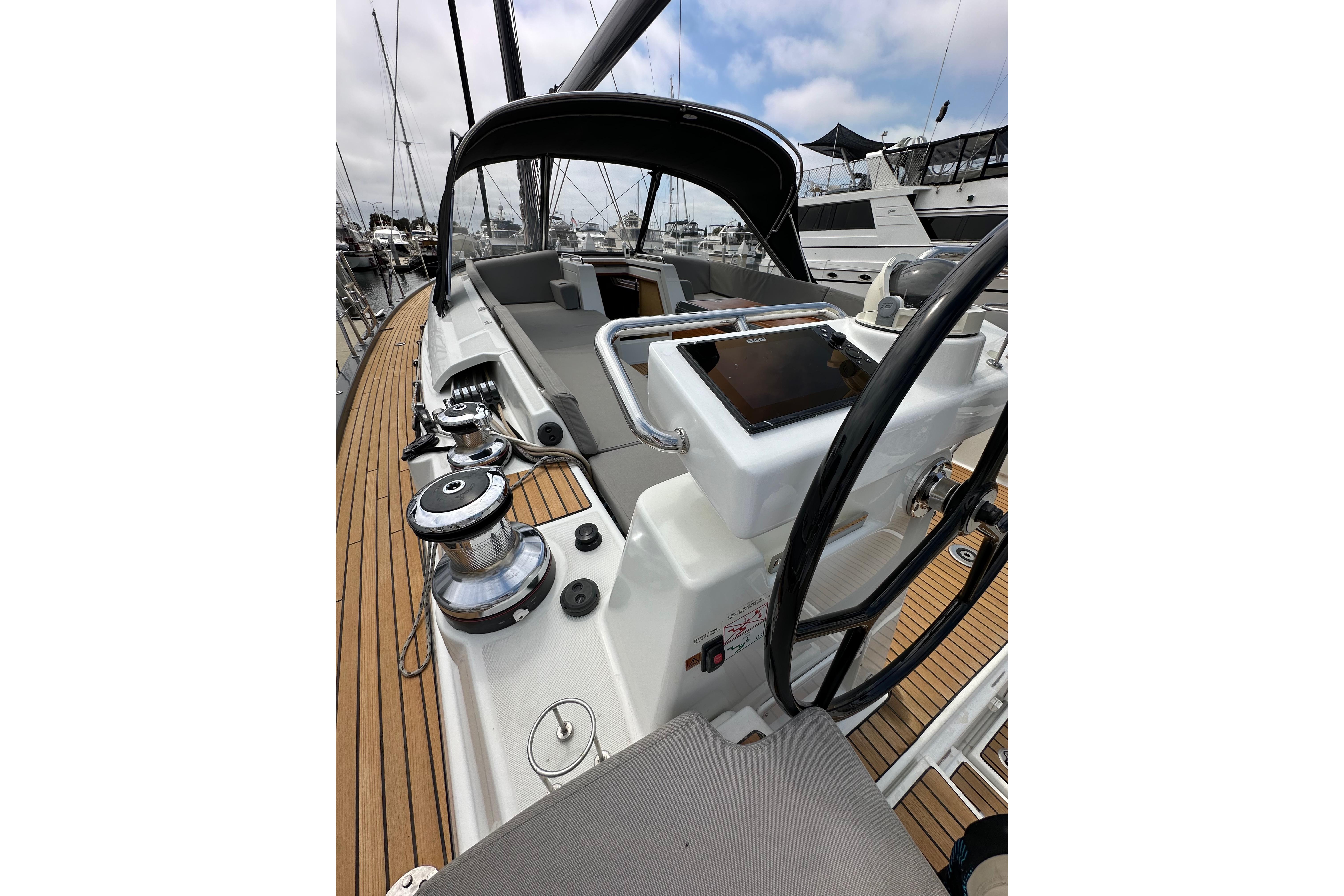2018 Jeanneau 54 sailboat cockpit with steering wheel and navigation equipment.