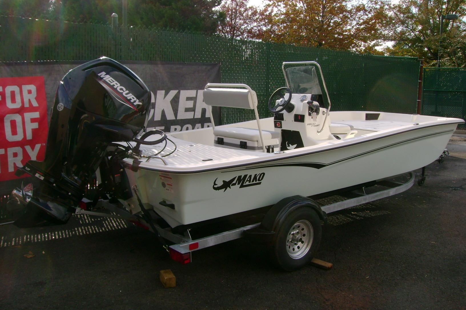 2026 Mako Pro Skiff 17 CC boat on trailer with Mercury outboard motor.