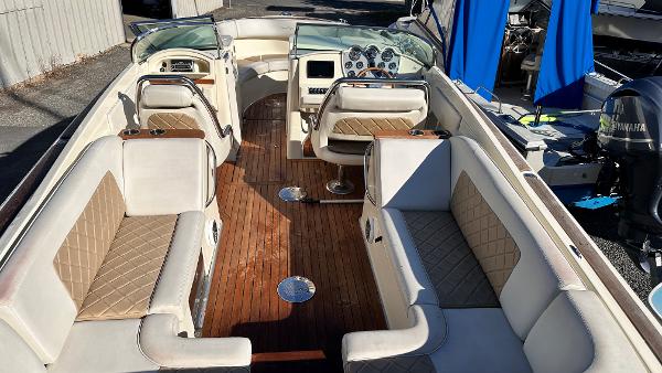 2014 Chris-Craft 28 LAUNCH boat interior with beige seating and wooden flooring.