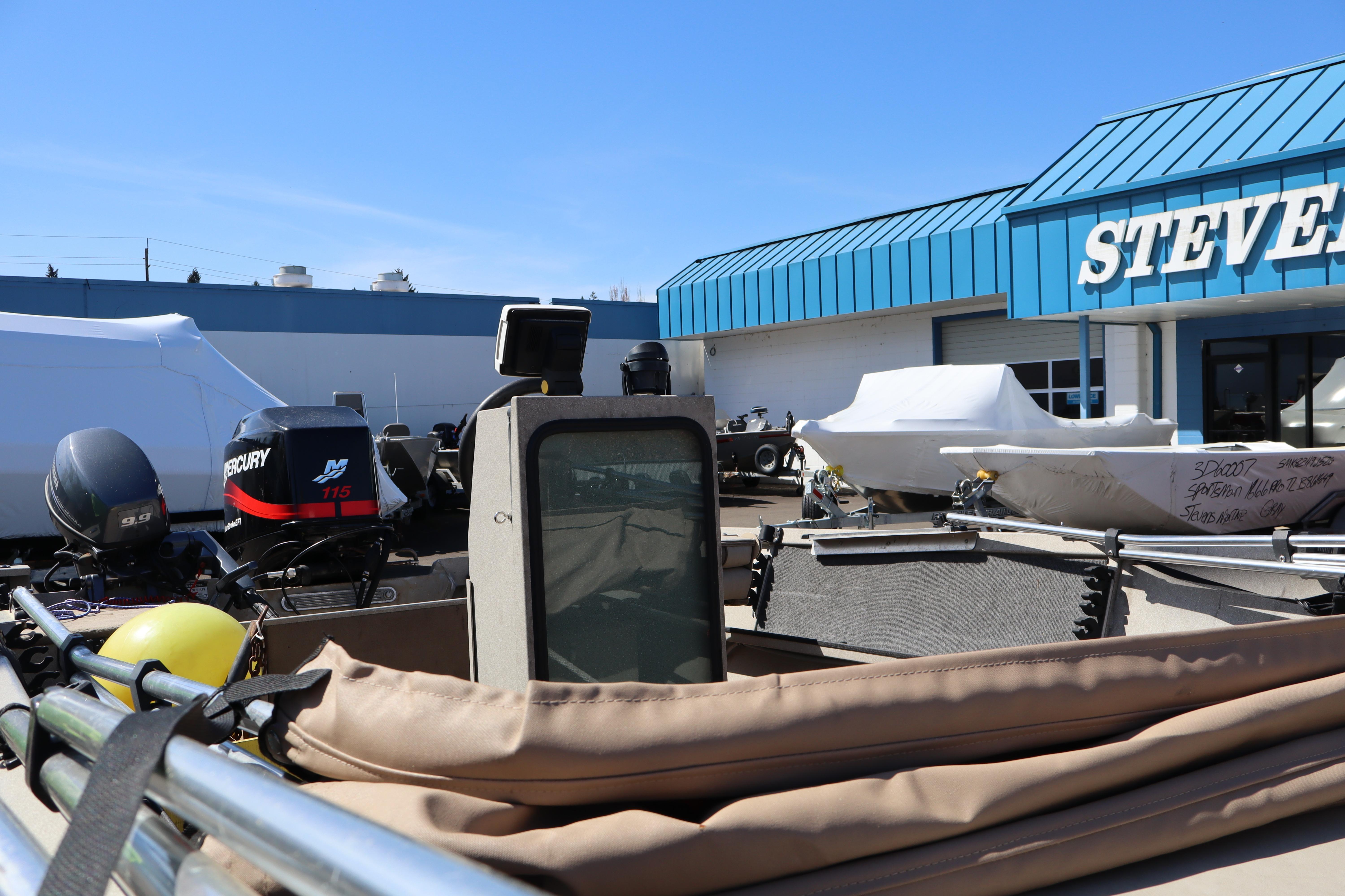 2002 Alumaweld SUPER VEE LS boat with Mercury engine at dealership, sunny day.
