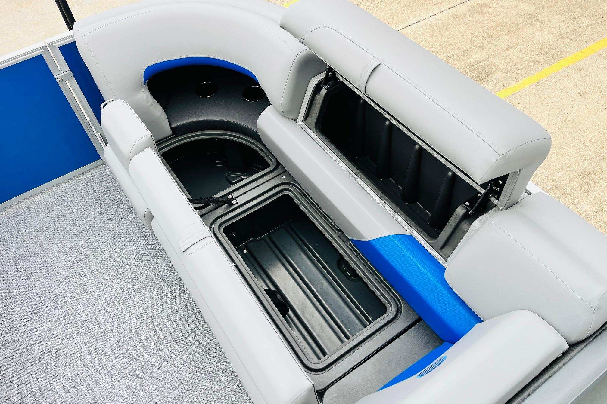 2026 Sun Tracker Party Barge 22 RF DLX interior seating with storage compartments.