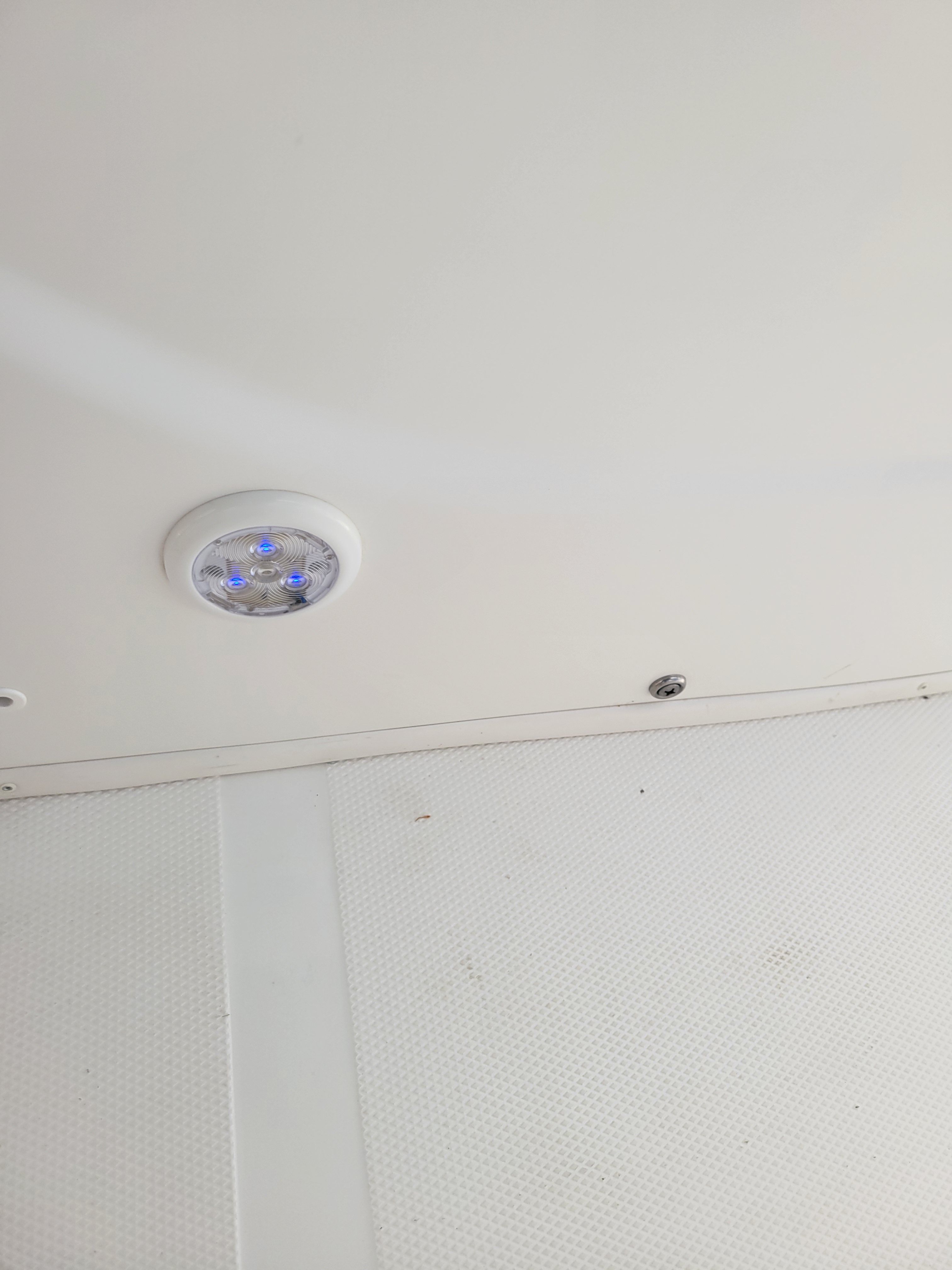 Interior view of a boat with an LED light on the ceiling.