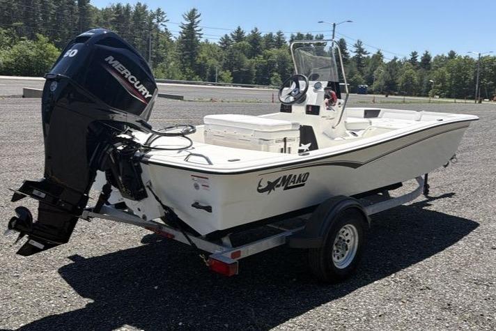 2026 Mako Pro Skiff 15 CC boat on trailer with Mercury outboard motor.