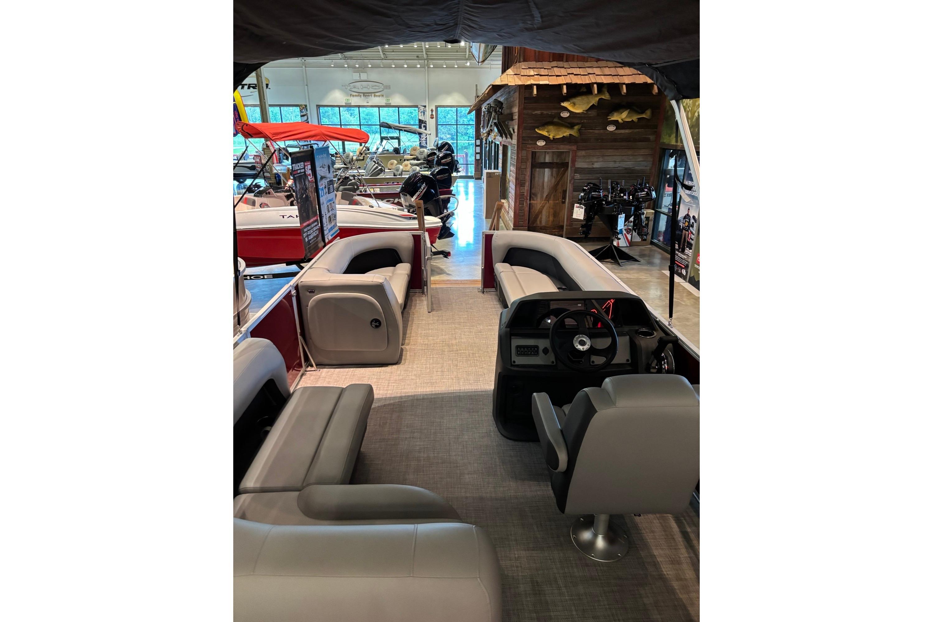 Interior view of 2026 Sun Tracker Party Barge 18 DLX pontoon boat in showroom.