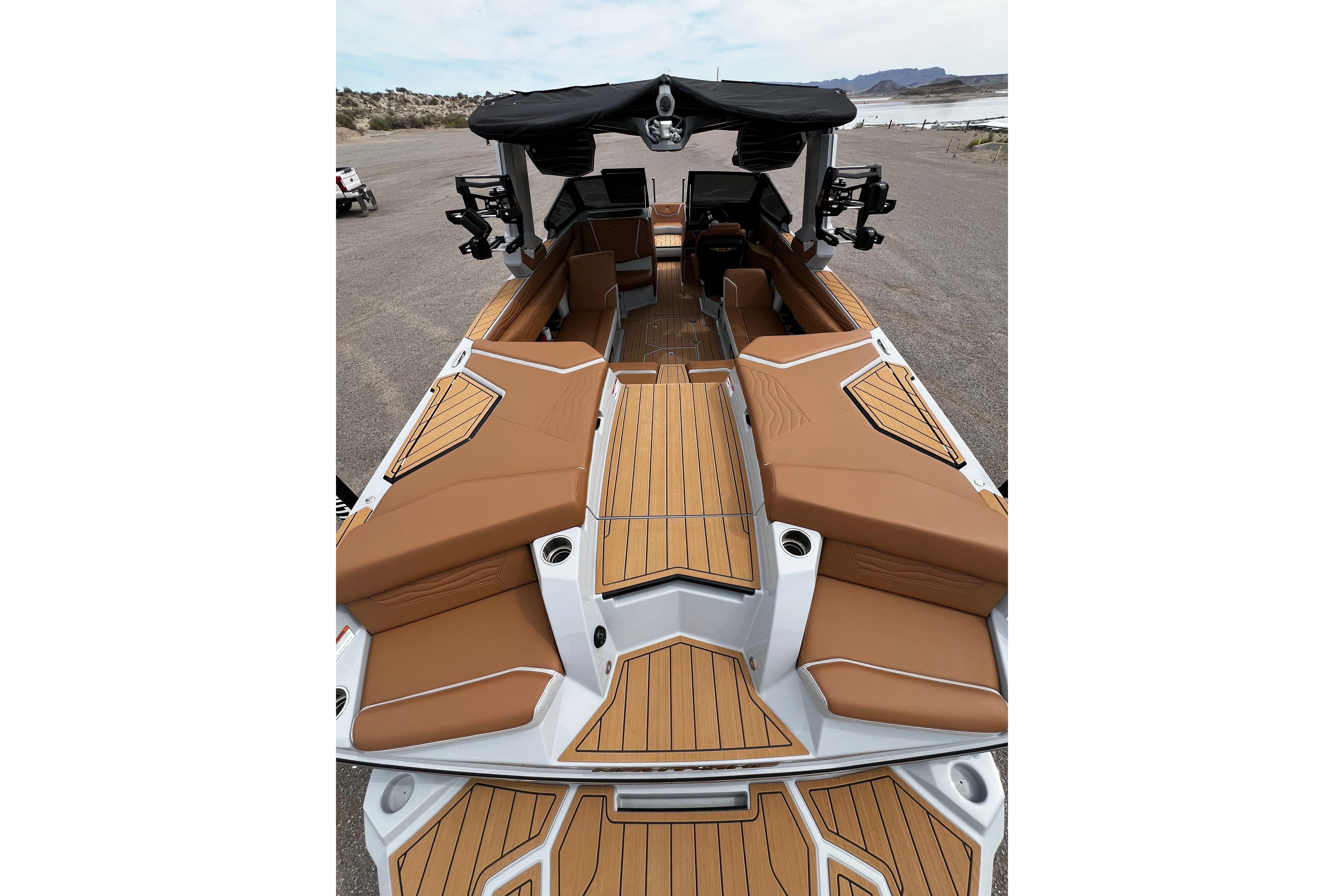2026 Nautique Super Air Nautique G25 boat interior with tan seating and wood accents.