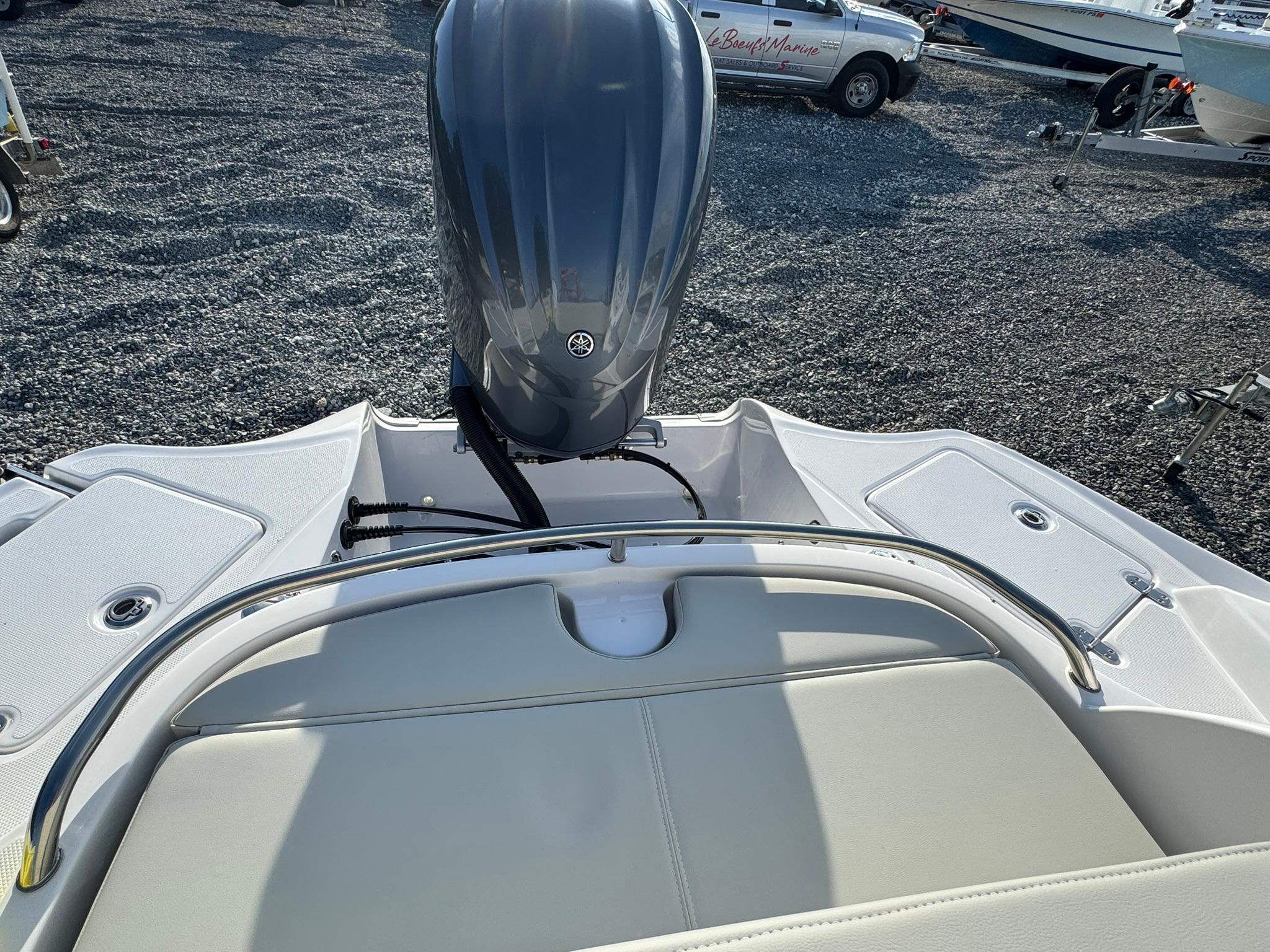2025 SouthWind 2600 boat with outboard motor, rear seating, and sleek design on gravel lot.