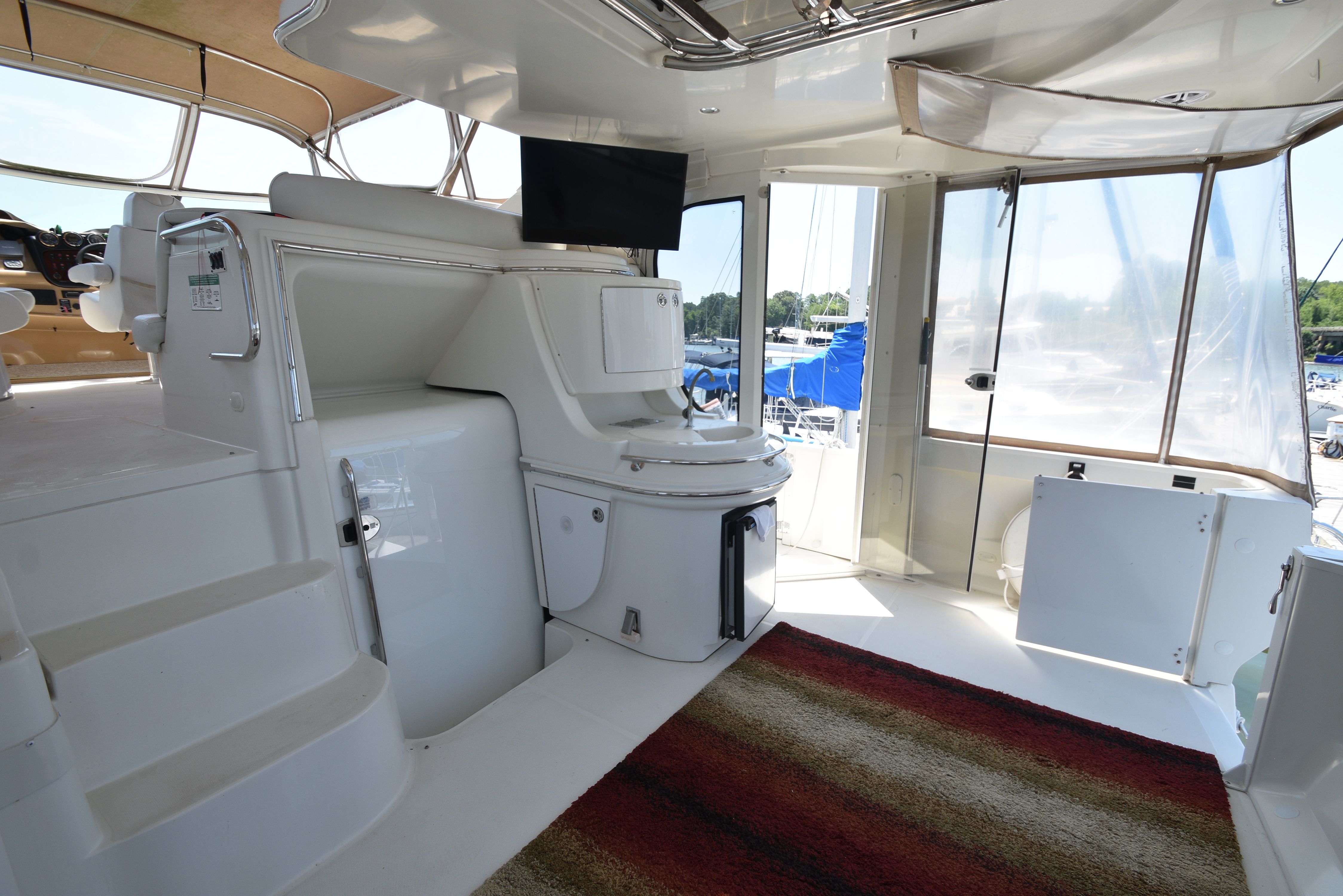 Interior of a 2004 Carver 466 Motor Yacht with stairs and a rug.