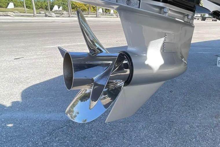 Shiny propeller of a 2009 Midnight Express 34 Open boat on pavement.