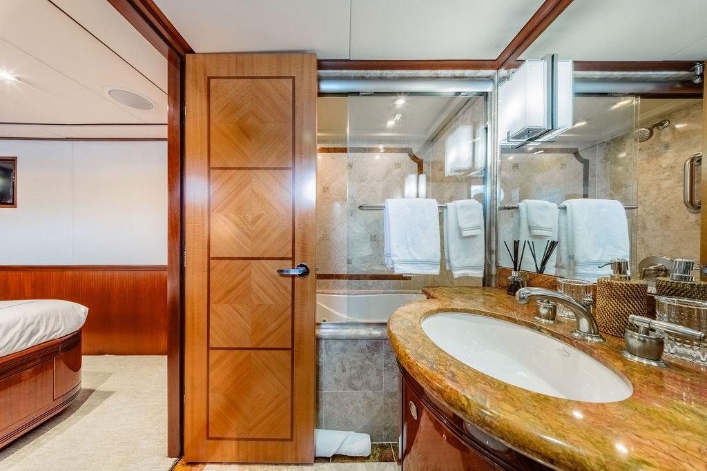 Luxurious bathroom on 2012 Ares Custom Marine Custom 141 yacht, featuring elegant wood and marble finishes.