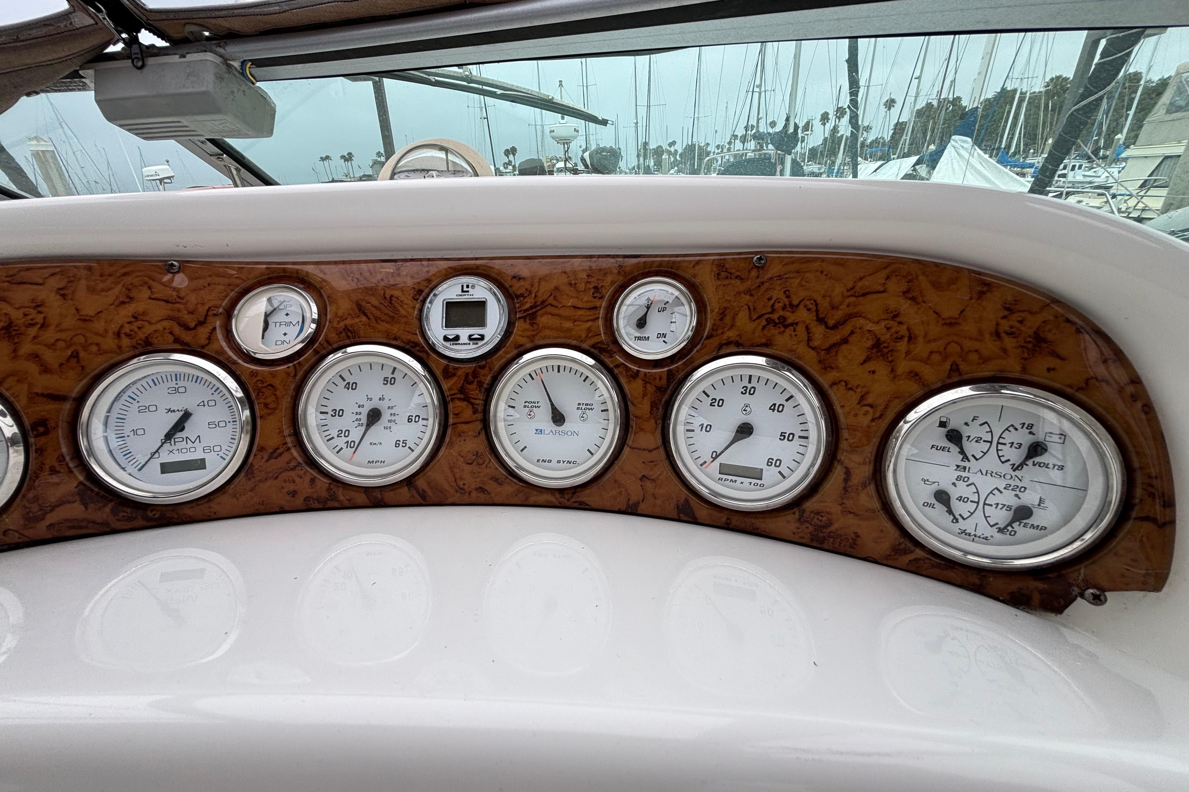 Dashboard of a 2004 Larson 310 boat with various gauges and controls.