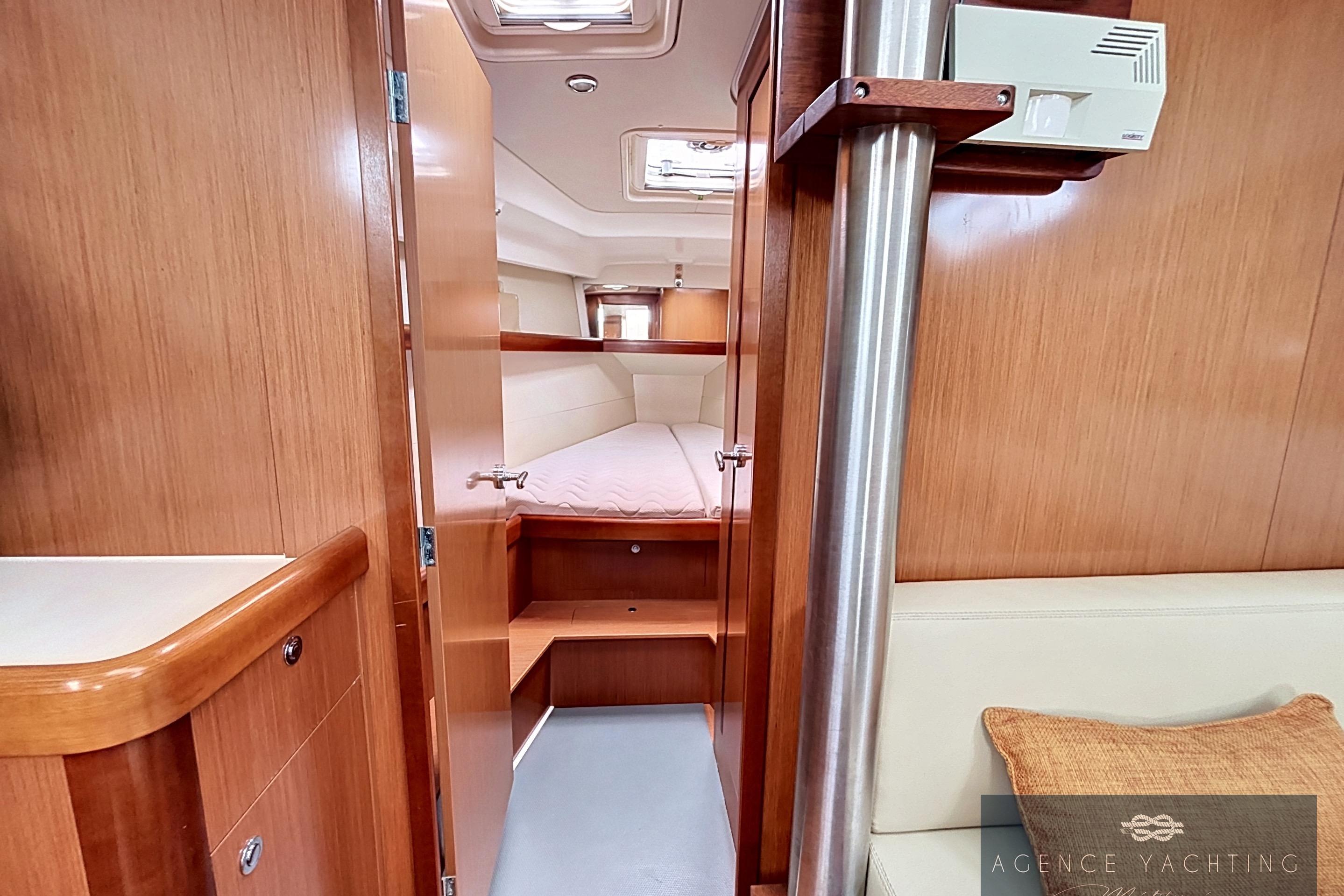 Interior of 2008 Beneteau Oceanis 40 yacht, featuring cozy wooden cabin and comfortable seating.