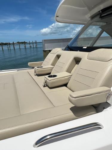 2019 Pursuit S 408 Sport boat with beige seating, cup holders, and ocean view.