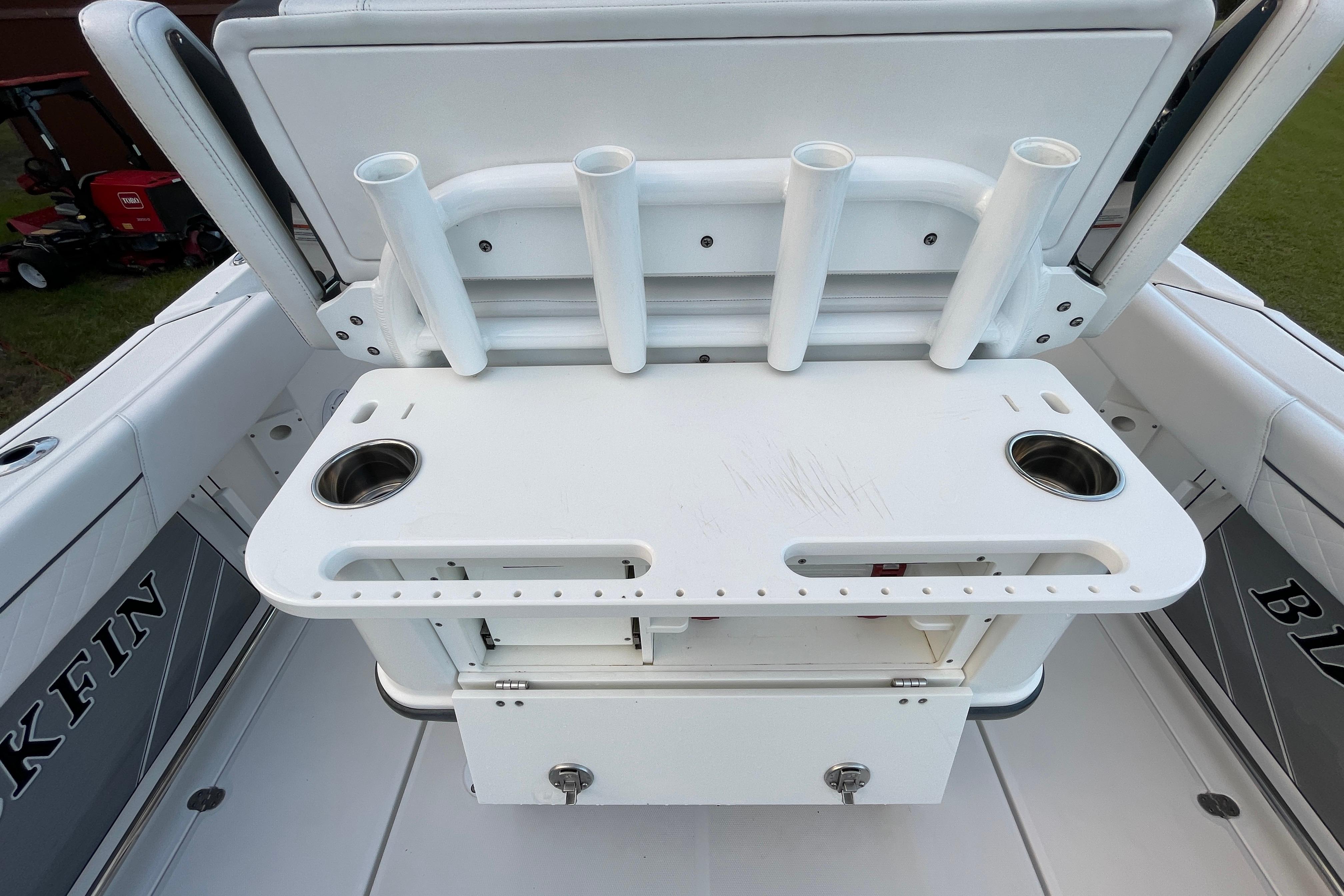 2022 Blackfin 252 CC boat with rod holders and storage compartment.
