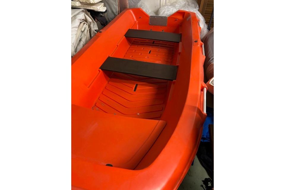 Red River Boats 350, 2022 model, featuring dual black seats, stored indoors.
