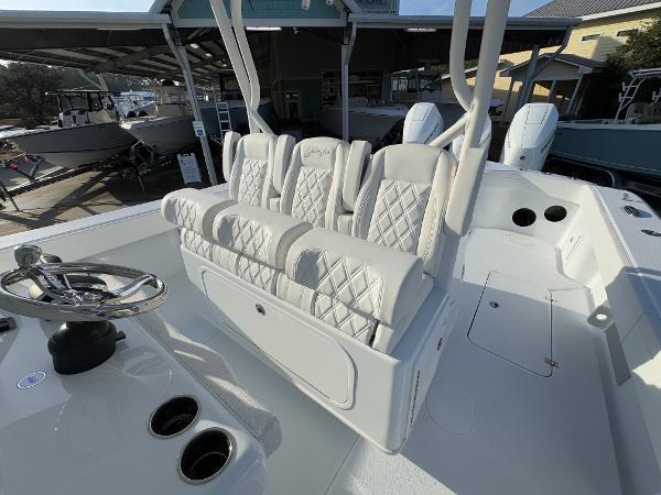 2025 Yellowfin 39 Offshore boat with luxurious white seating and steering wheel.